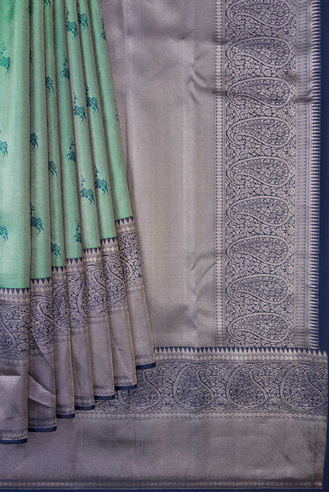 Pleats and pallu of Green Dual Tone Kanjivaram Tissue Silk Saree with Zari Brocade on the body and Fancy Border. 