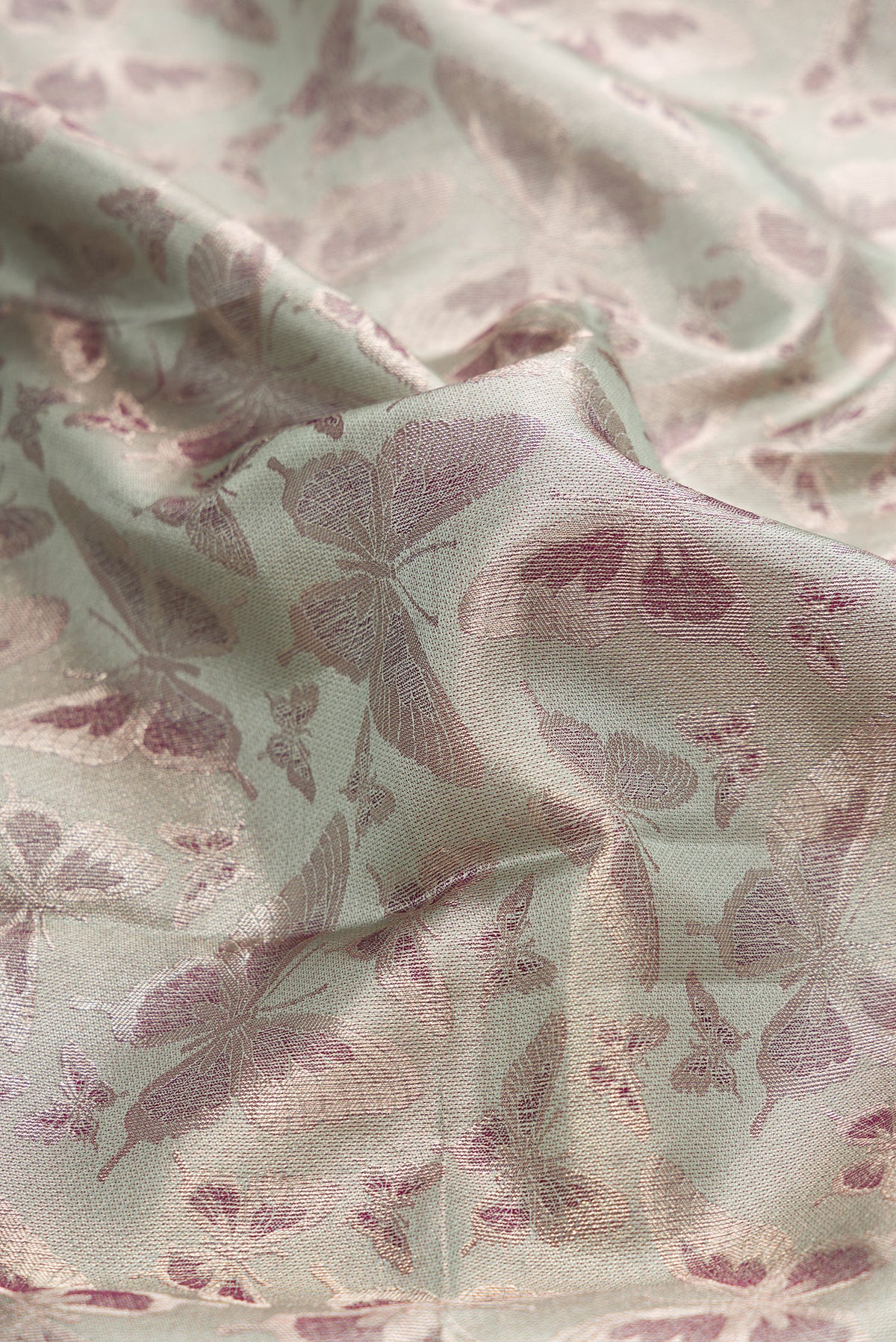 Close up of Light Green Dual Tone Kanjivaram Tissue Silk Saree with Zari Brocade on the body and Fancy Border.  displaying folds