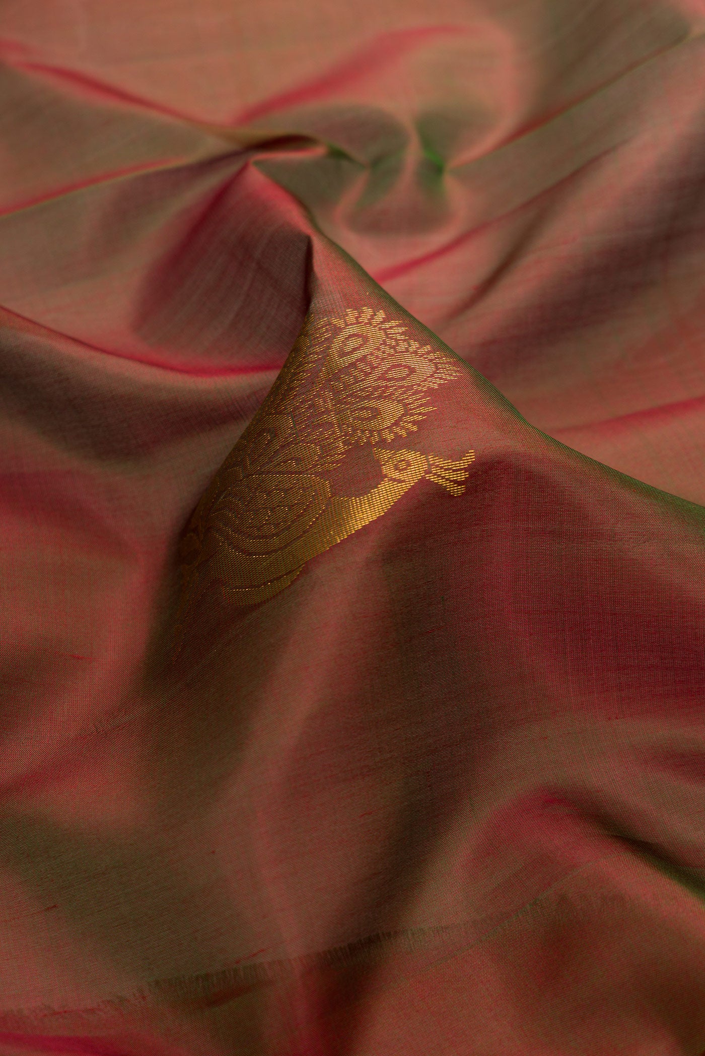 Close up of Bottle Green Dual Tone Soft Silk Saree with Zari Butta on the body and Zari Border.  displaying folds