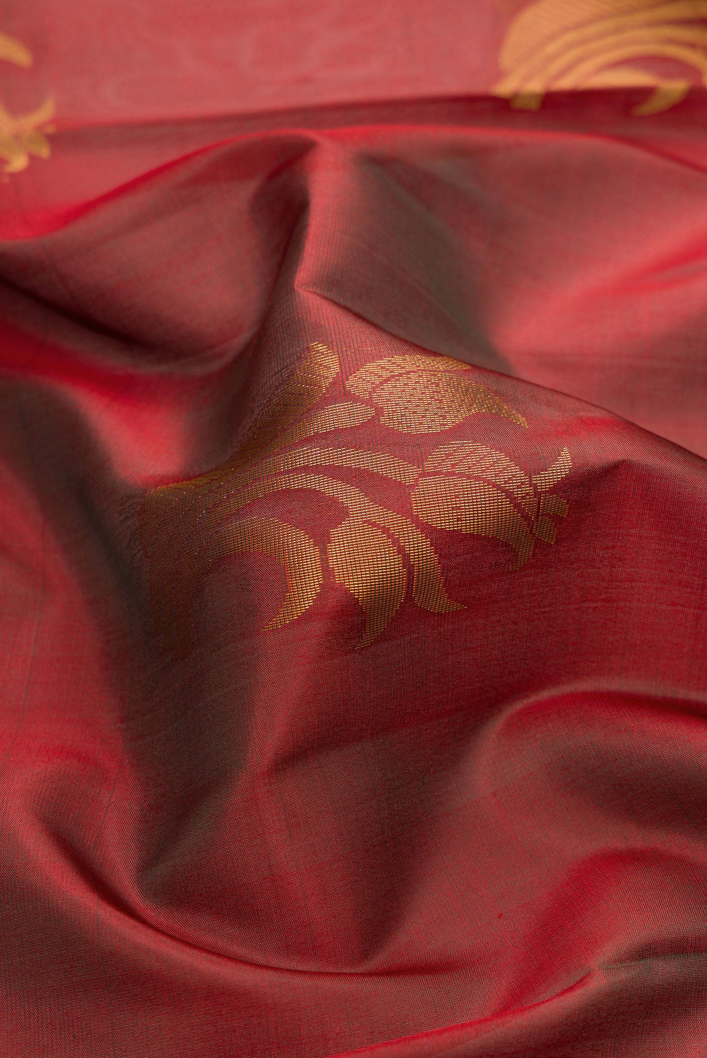 Close up of Maroon Dual Tone Soft Silk Saree with Zari Butta on the body and Fancy Border.  displaying folds