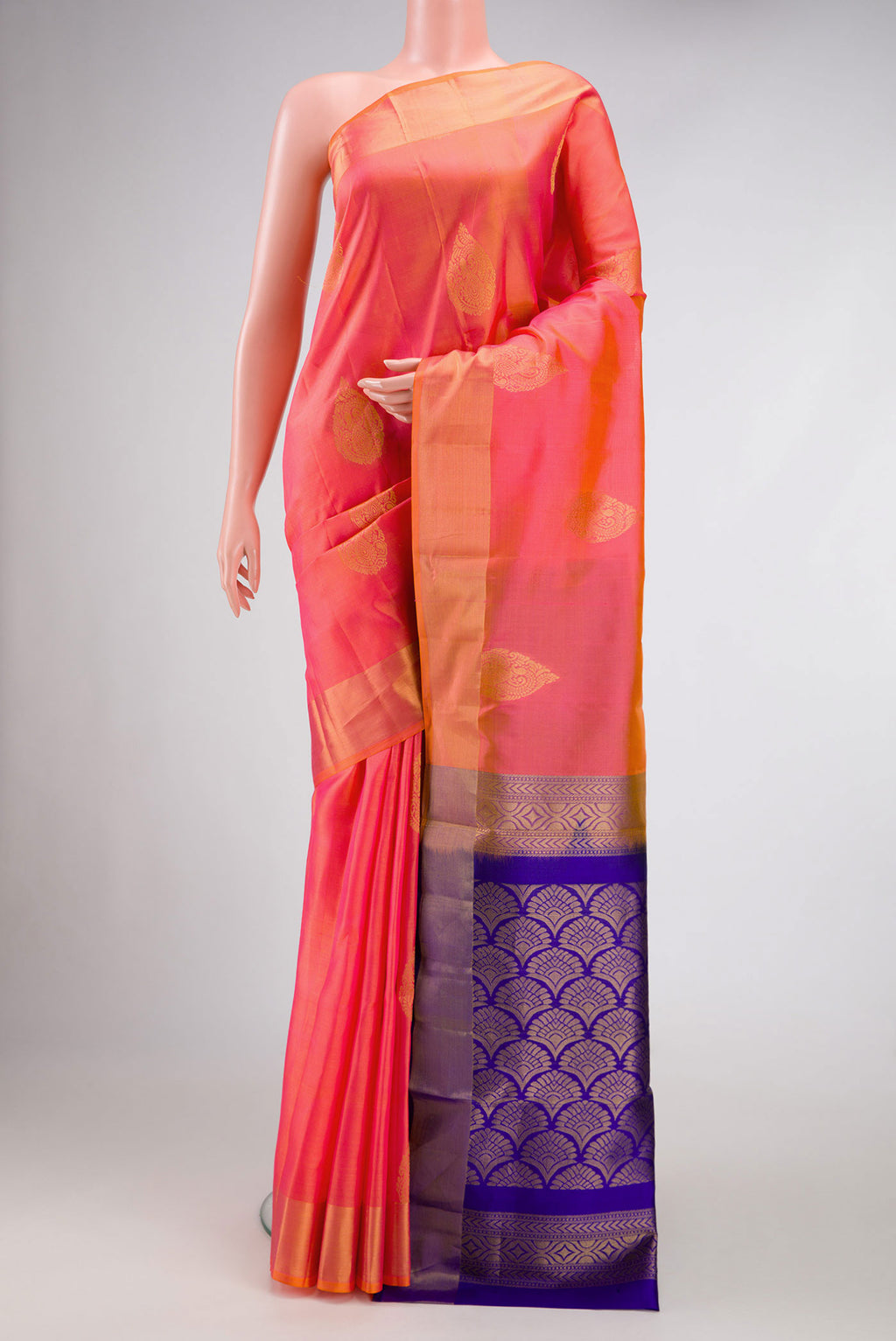 Brick Orange Dual Tone Soft Silk Saree with Zari Butta on the body and Zari Border.  displayed on a mannequin