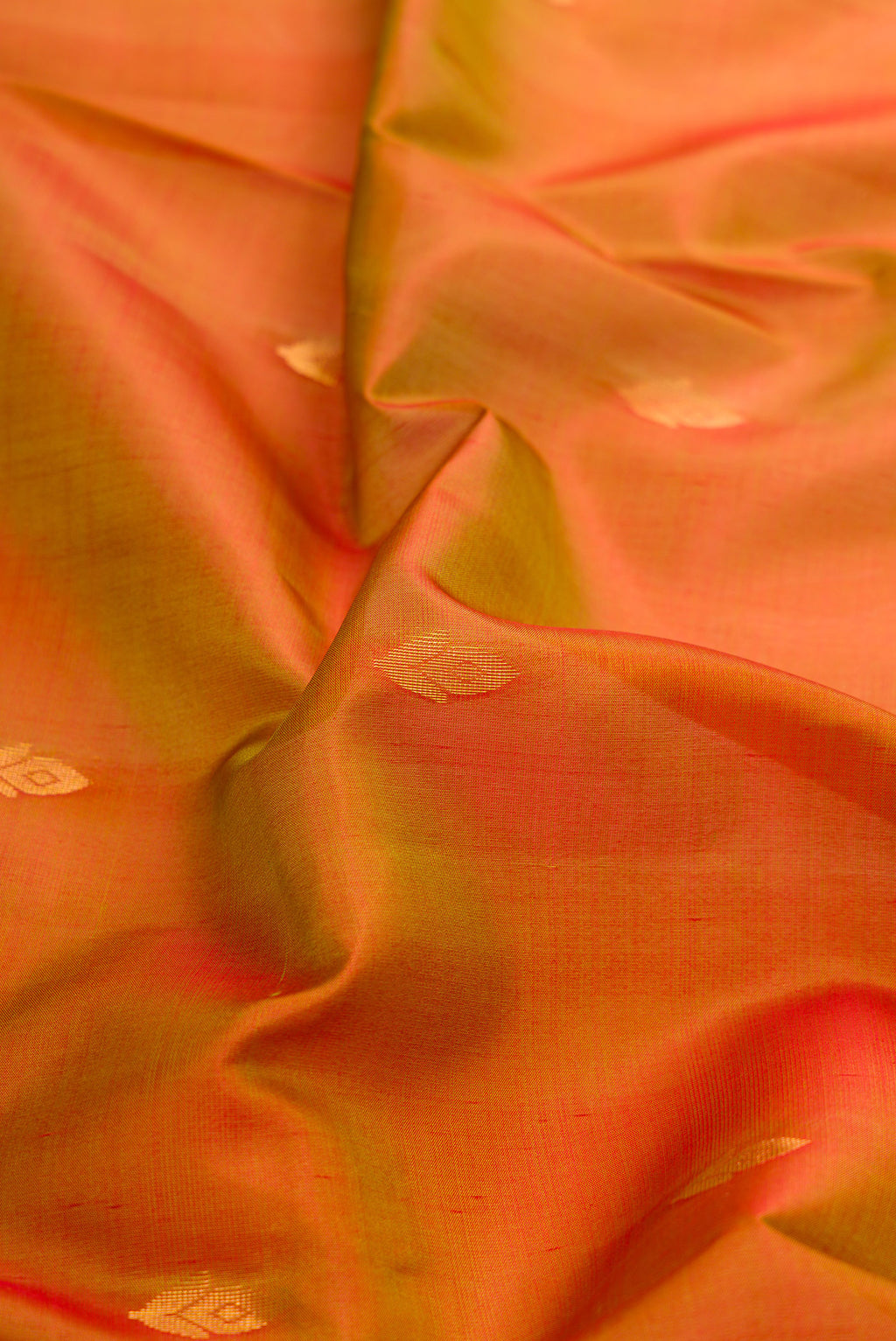 Close up of Mustard Dual Tone Soft Silk Saree with Zari Butta on the body and Fancy Border.  displaying folds