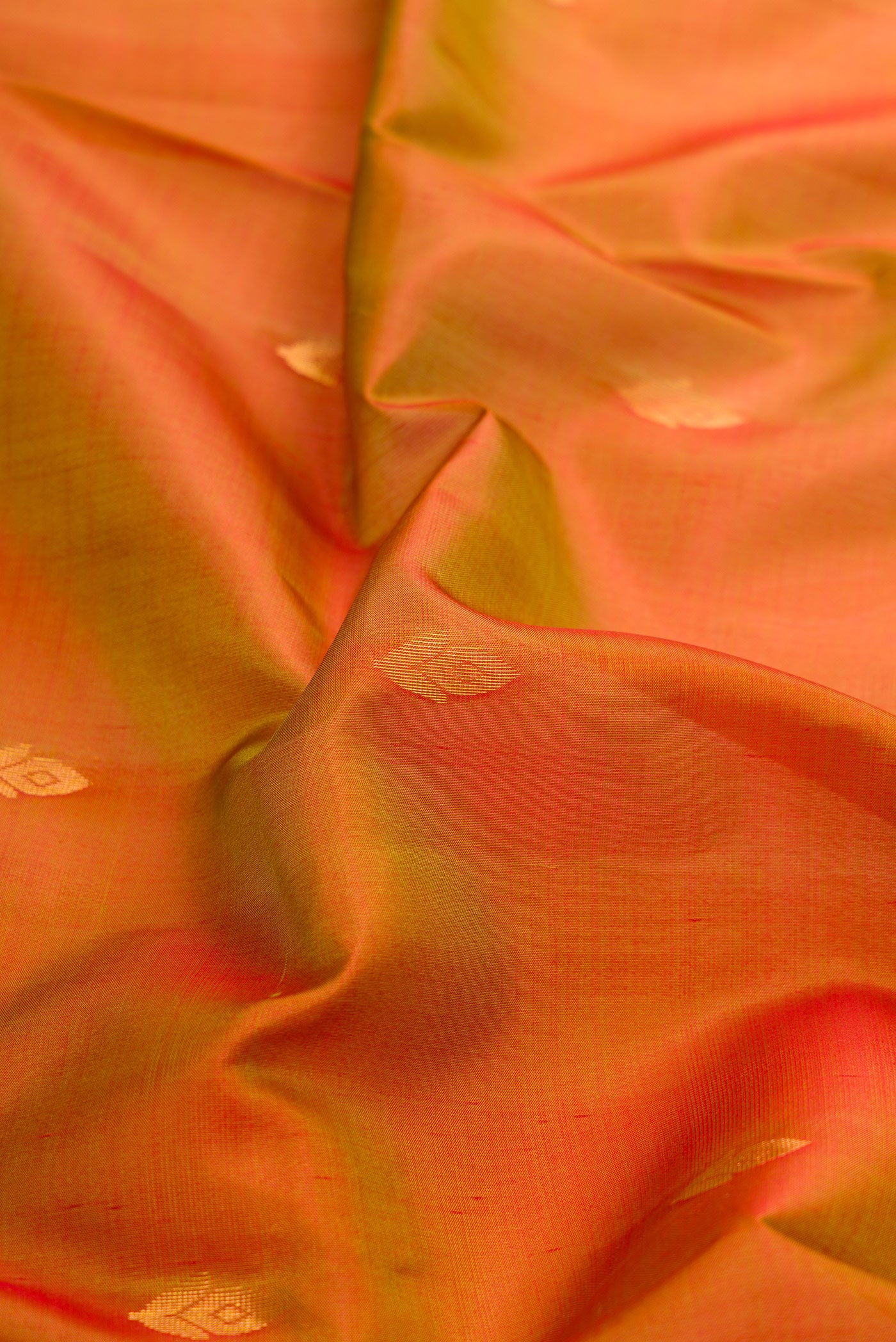 Close up of Mustard Dual Tone Soft Silk Saree with Zari Butta on the body and Fancy Border.  displaying folds