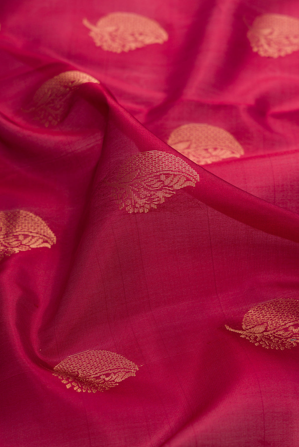 Close up of Maroon Dual Tone Soft Silk Saree with Zari Butta on the body and Zari Border.  displaying folds