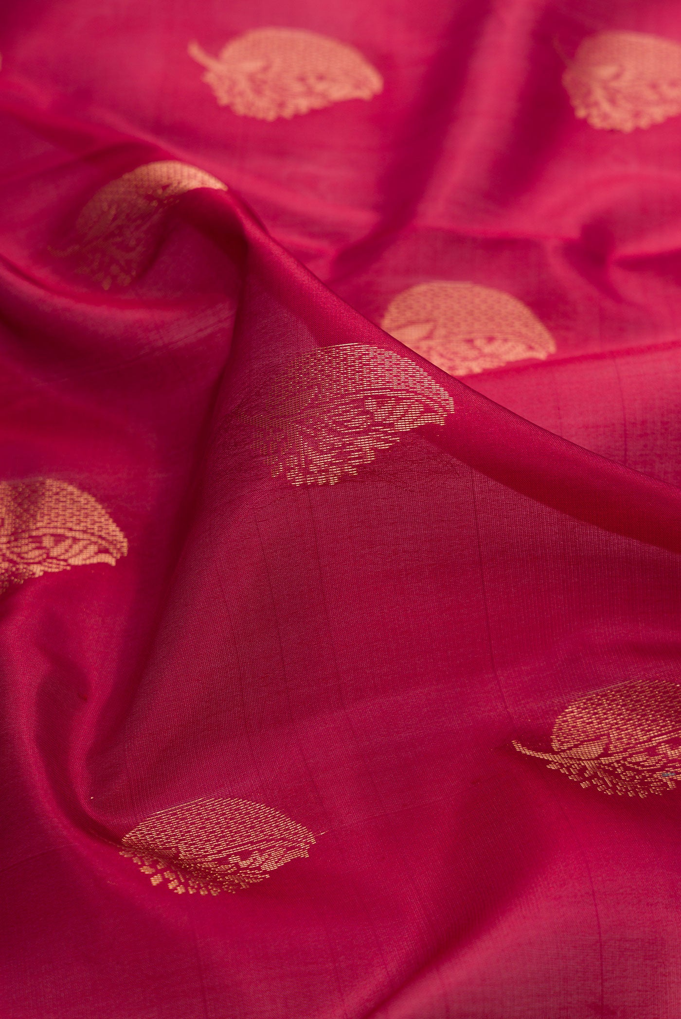 Close up of Maroon Dual Tone Soft Silk Saree with Zari Butta on the body and Zari Border.  displaying folds
