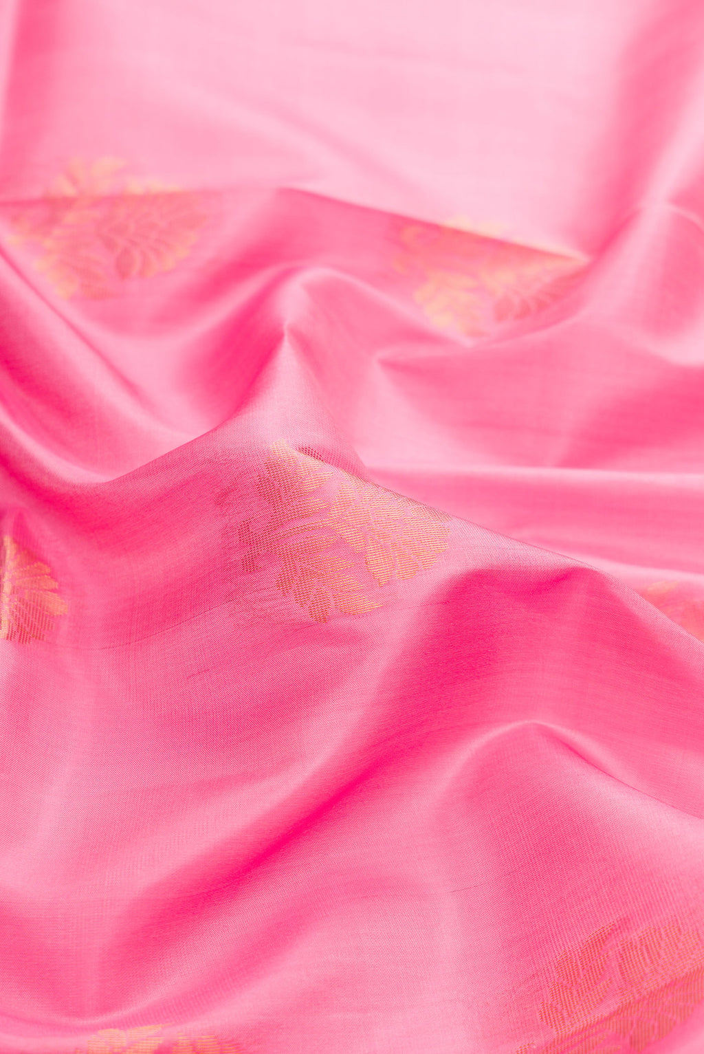 Close up of Pink Dual Tone Soft Silk Saree with Zari Butta on the body and Fancy Border.  displaying folds