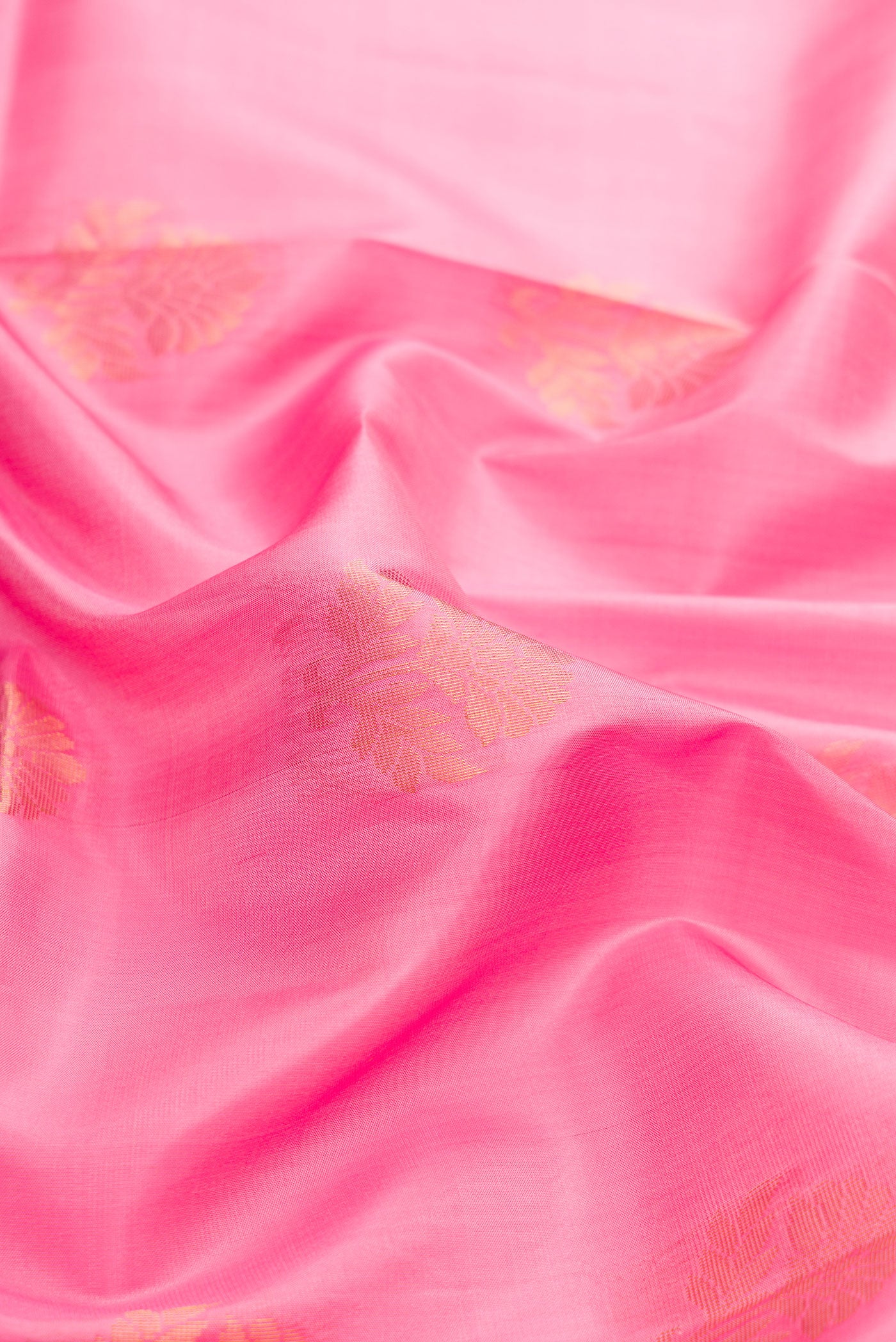 Close up of Pink Dual Tone Soft Silk Saree with Zari Butta on the body and Fancy Border.  displaying folds