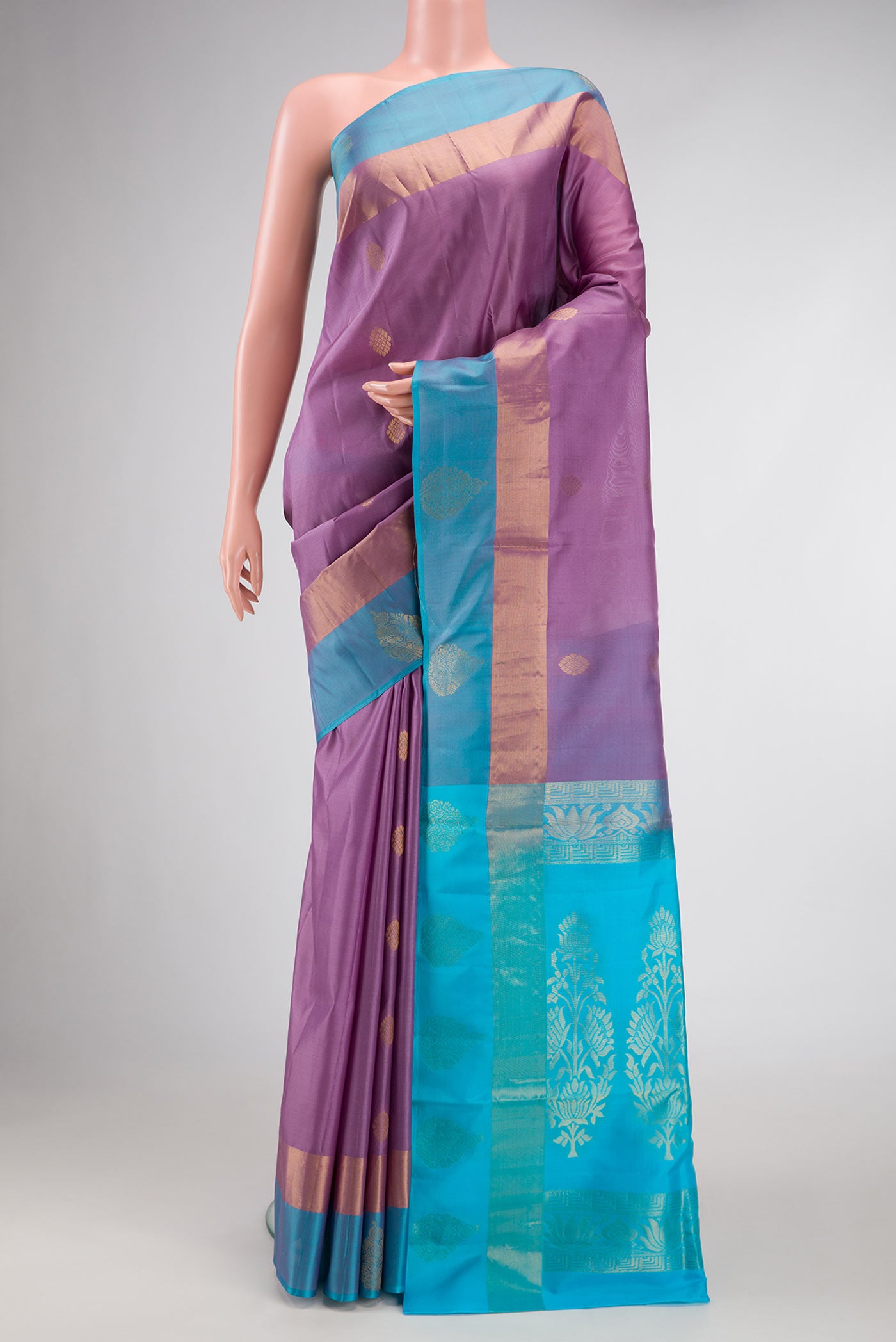 Purple Dual Tone Soft Silk Saree with Zari Butta on the body and Fancy Border.  displayed on a mannequin