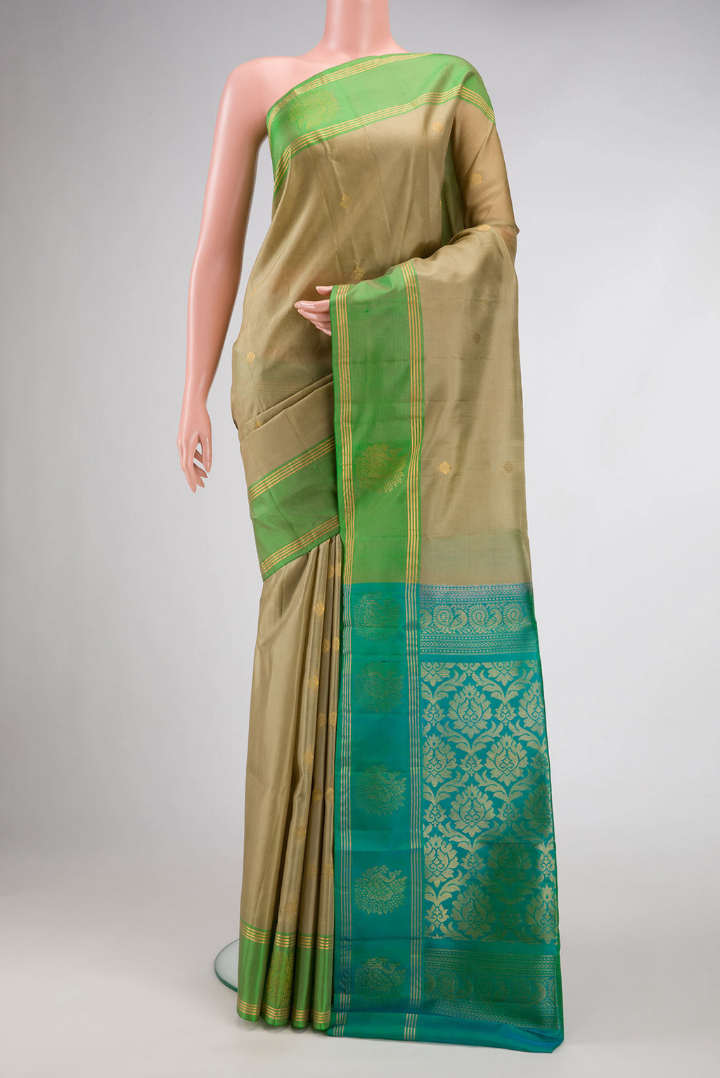 Mehandi Green Dual Tone Soft Silk Saree with Zari Butta on the body and Fancy Border.  displayed on a mannequin