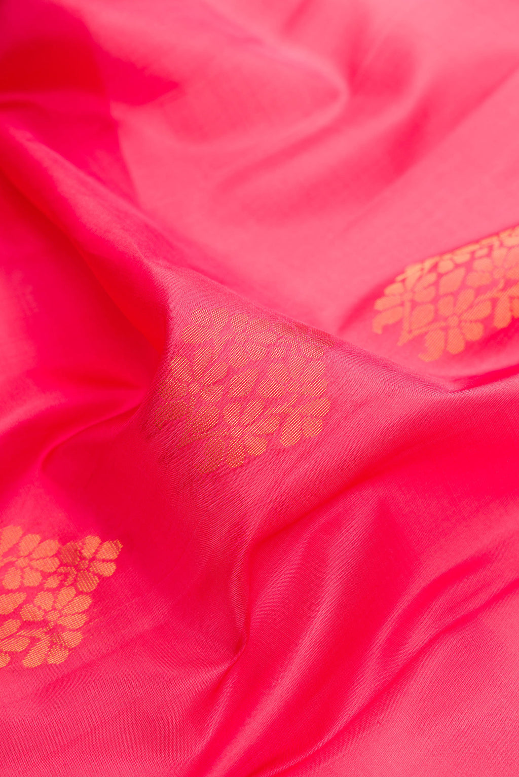 Close up of Pink Dual Tone Soft Silk Saree with Zari Butta on the body and Fancy Border.  displaying folds