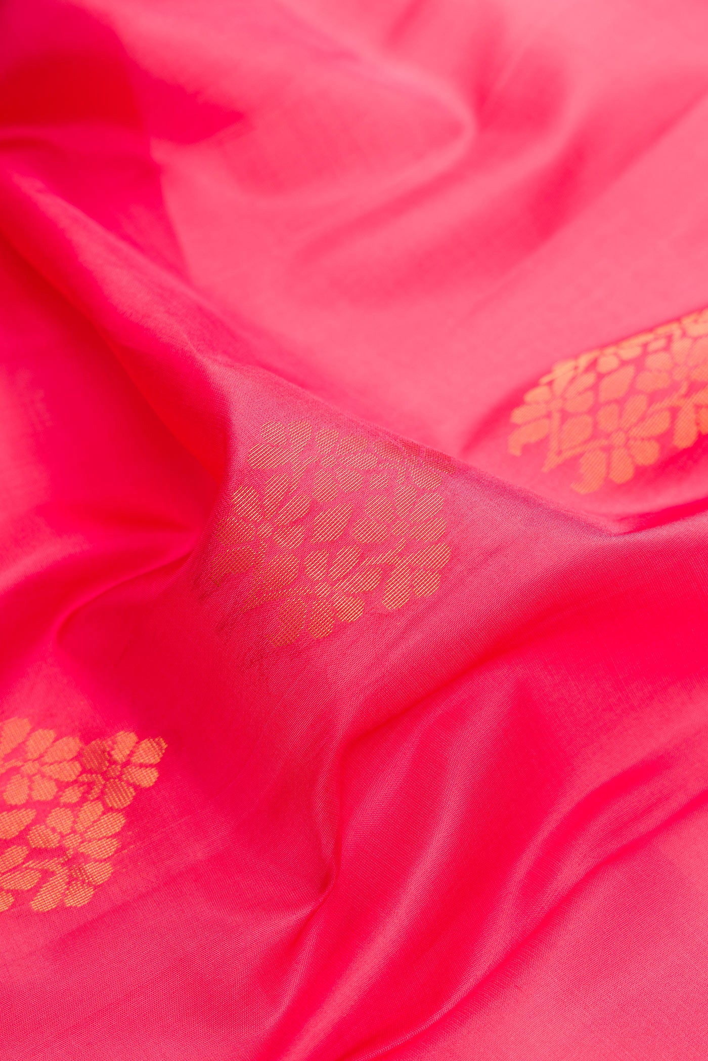 Close up of Pink Dual Tone Soft Silk Saree with Zari Butta on the body and Fancy Border.  displaying folds