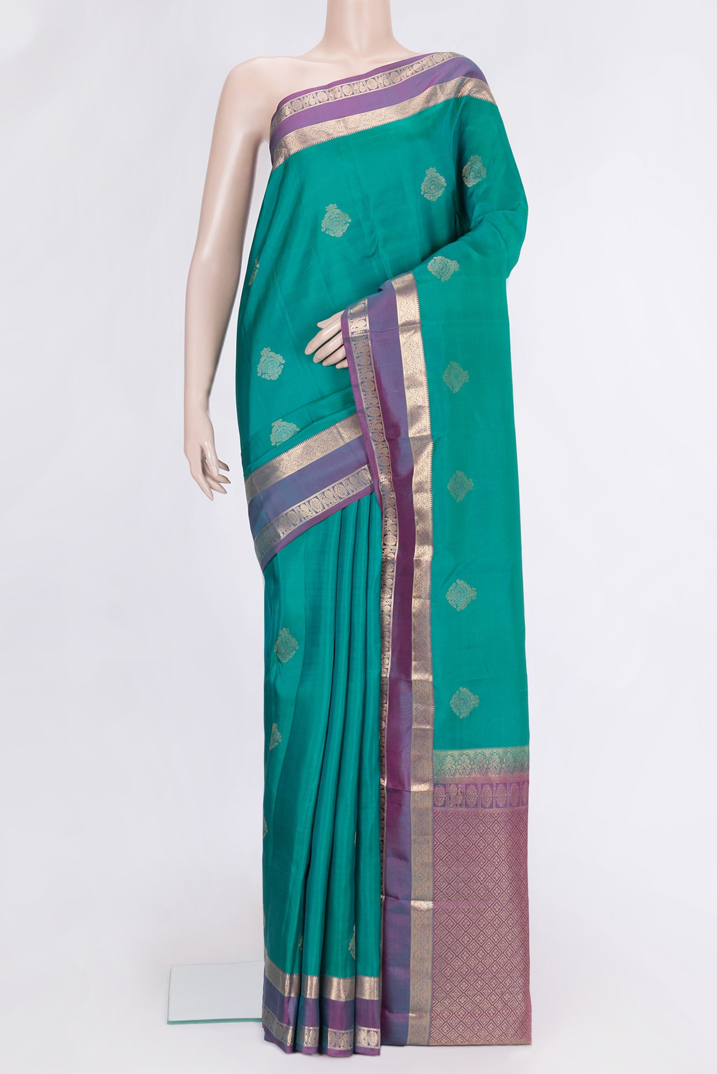 Green Dual Tone Kanchipuram Silk Saree with Zari Butta on the body and Zari Border.  displayed on a mannequin
