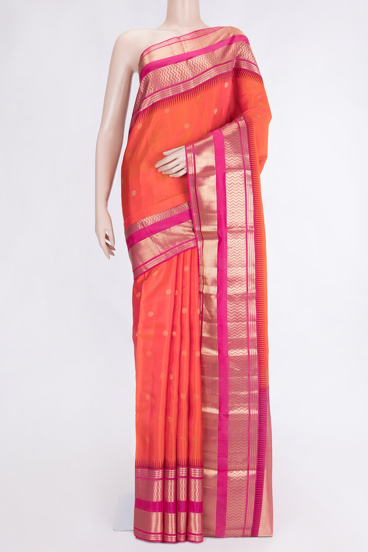 Orange Dual Tone Kanjivaram Silk Saree with Zari Butta on the body and Zari Border.  displayed on a mannequin