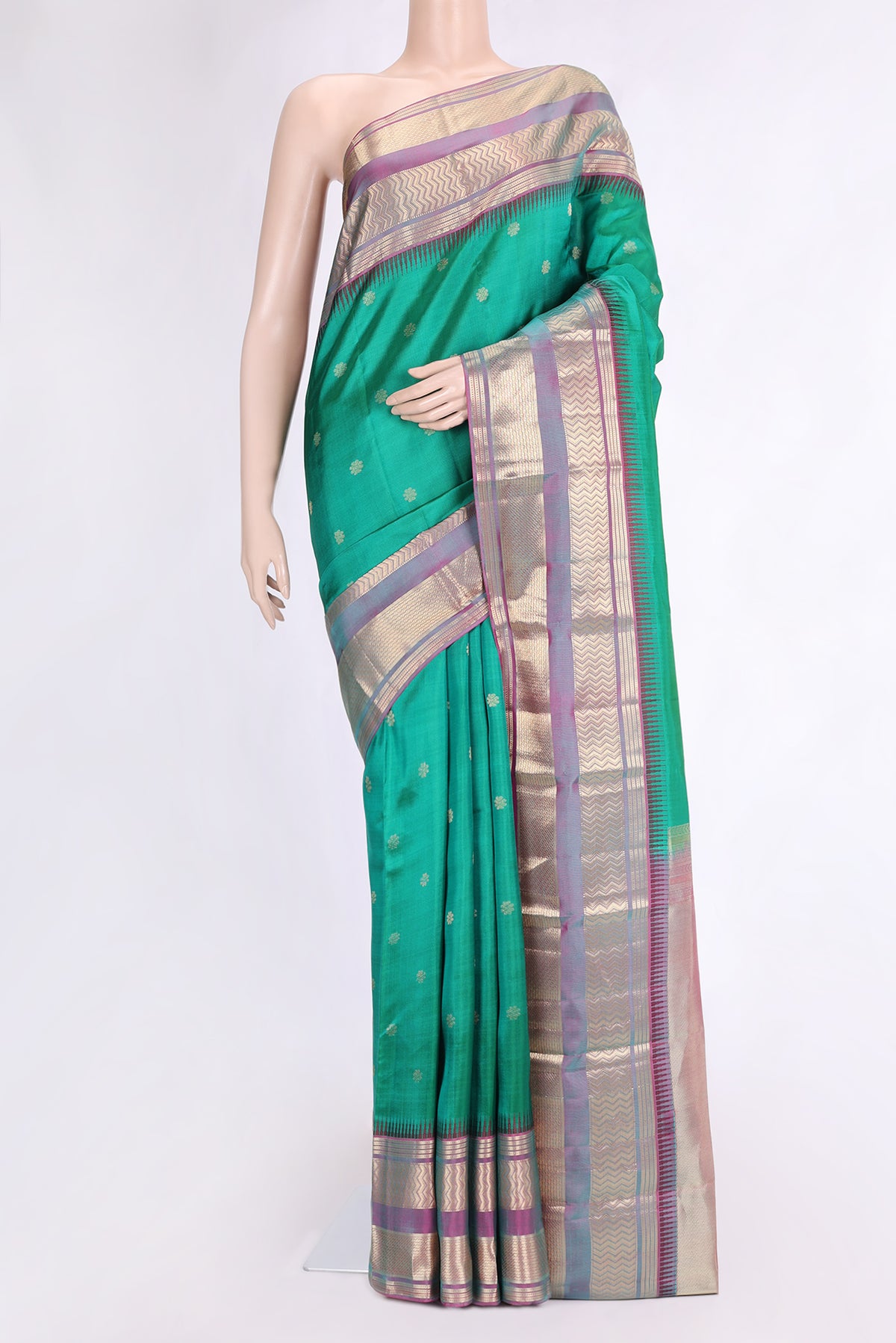 Green Dual Tone Kanjivaram Silk Saree with Zari Butta on the body and Zari Border.  displayed on a mannequin
