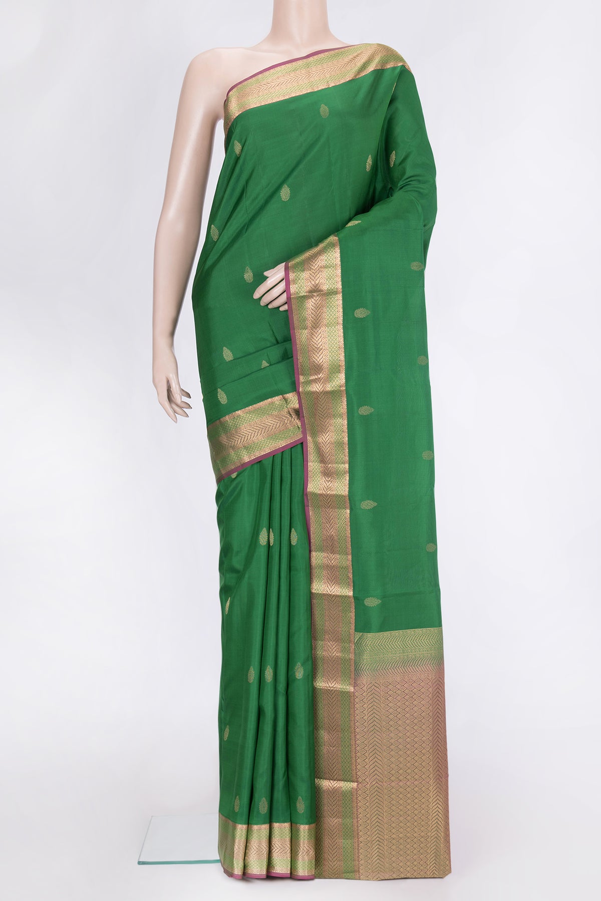 Green Dual Tone Kanchipuram Silk Saree with Zari Butta on the body and Zari Border.  displayed on a mannequin