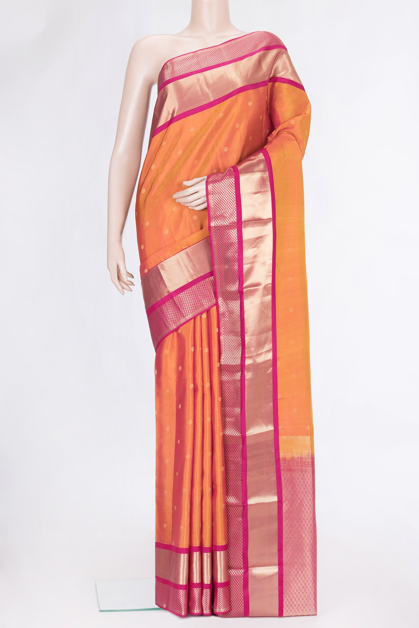Mustard Dual Tone Kanchipuram Silk Saree with Zari Butta on the body and Zari Border.  displayed on a mannequin