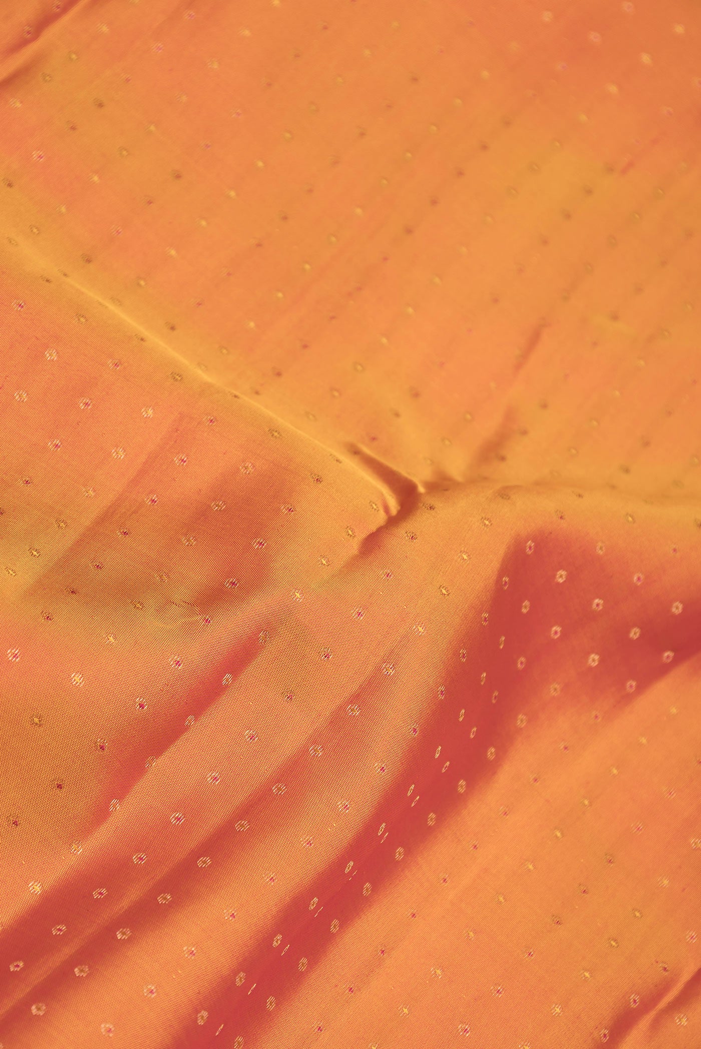Close up of Mustard Dual Tone Kanchipuram Silk Saree with Zari Butta on the body and Zari Border.  displaying folds