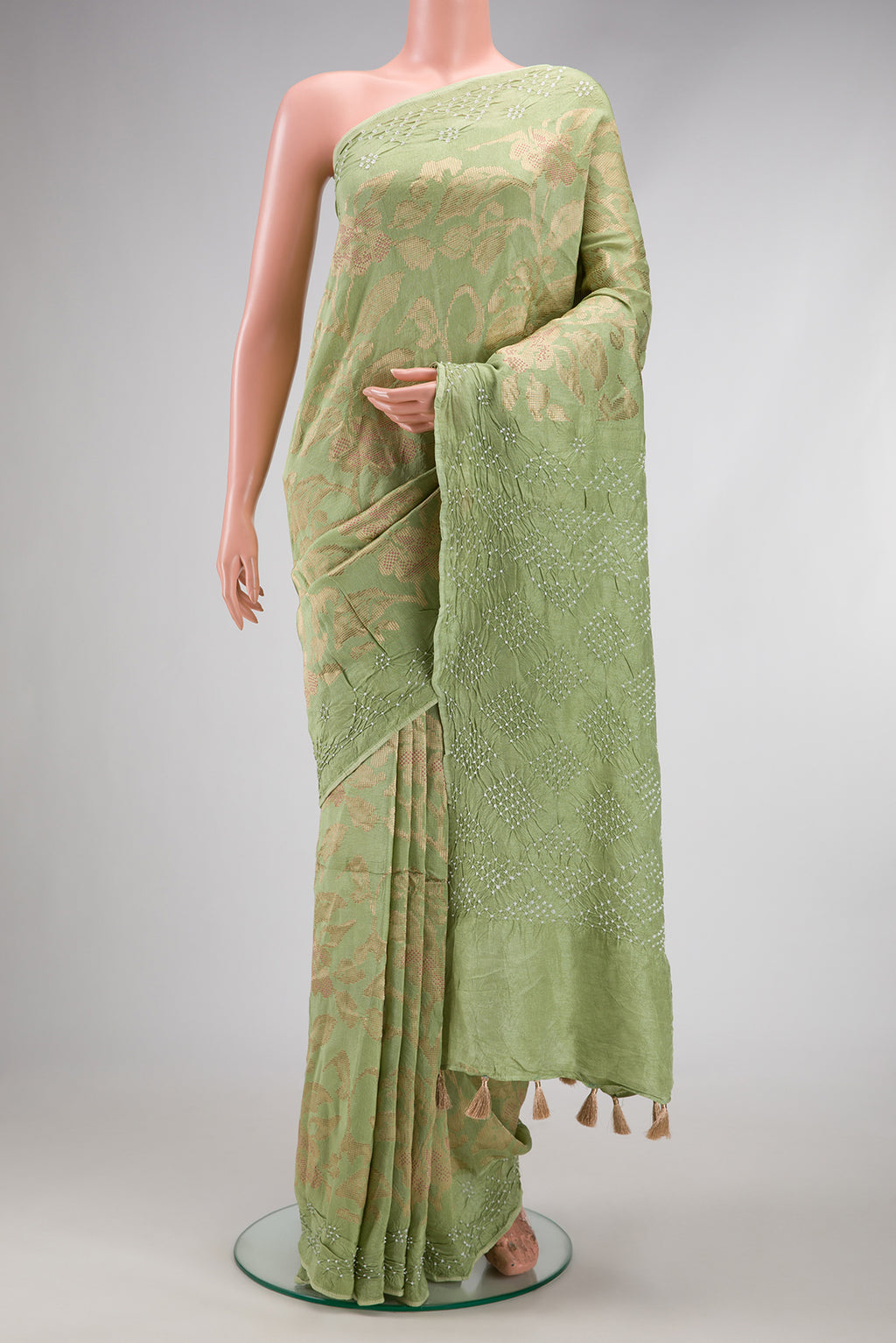Pista Green Blended Bandhani Silk Saree with Zari Brocade on the body and Fancy Border.  displayed on a mannequin