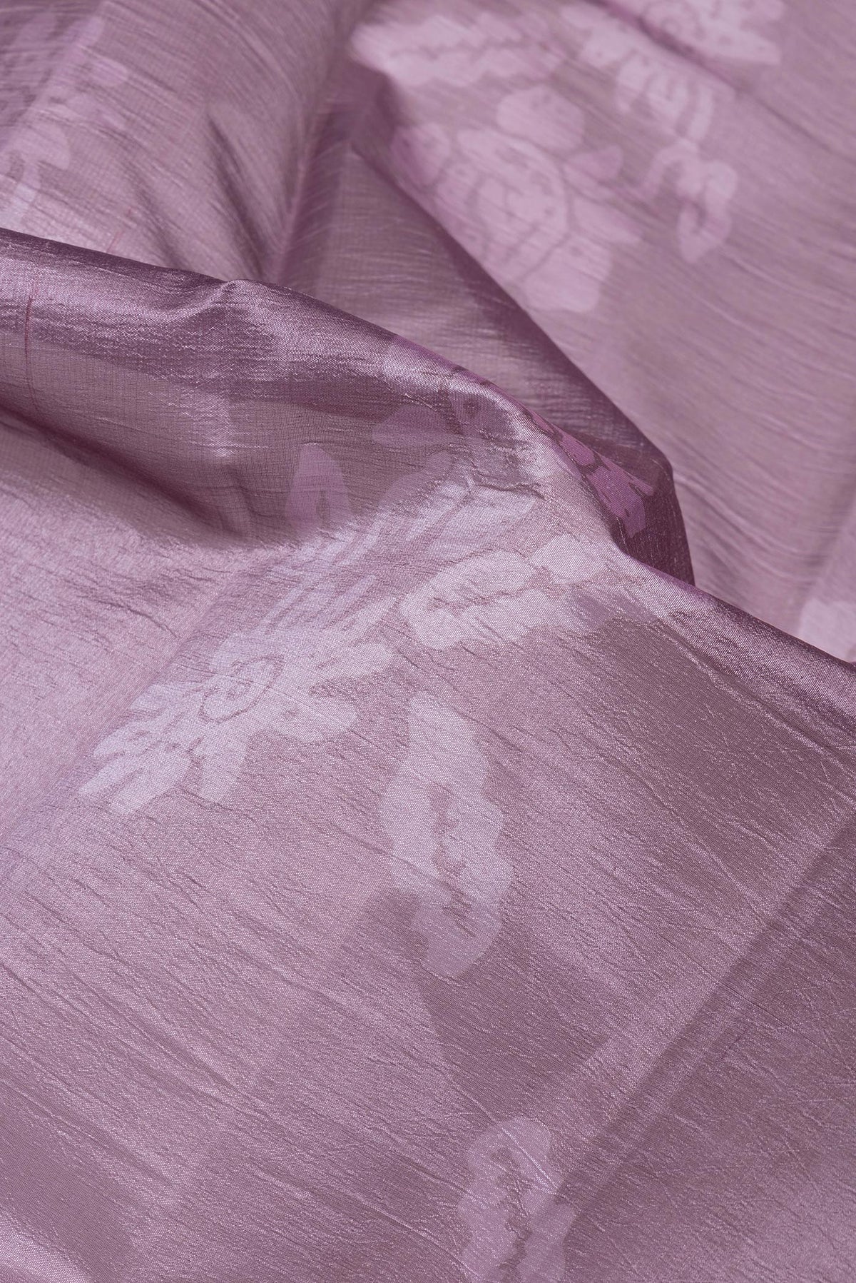 Close up of Lavender Tussar Silk Saree with Printed design on the body and Printed Border.  displaying folds
