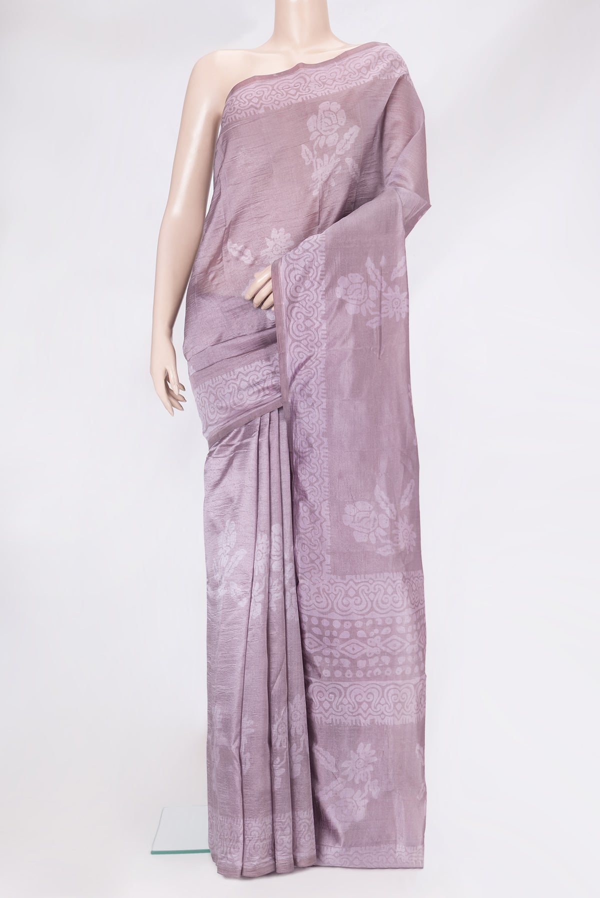 Lavender Tussar Silk Saree with Printed design on the body and Printed Border.  displayed on a mannequin