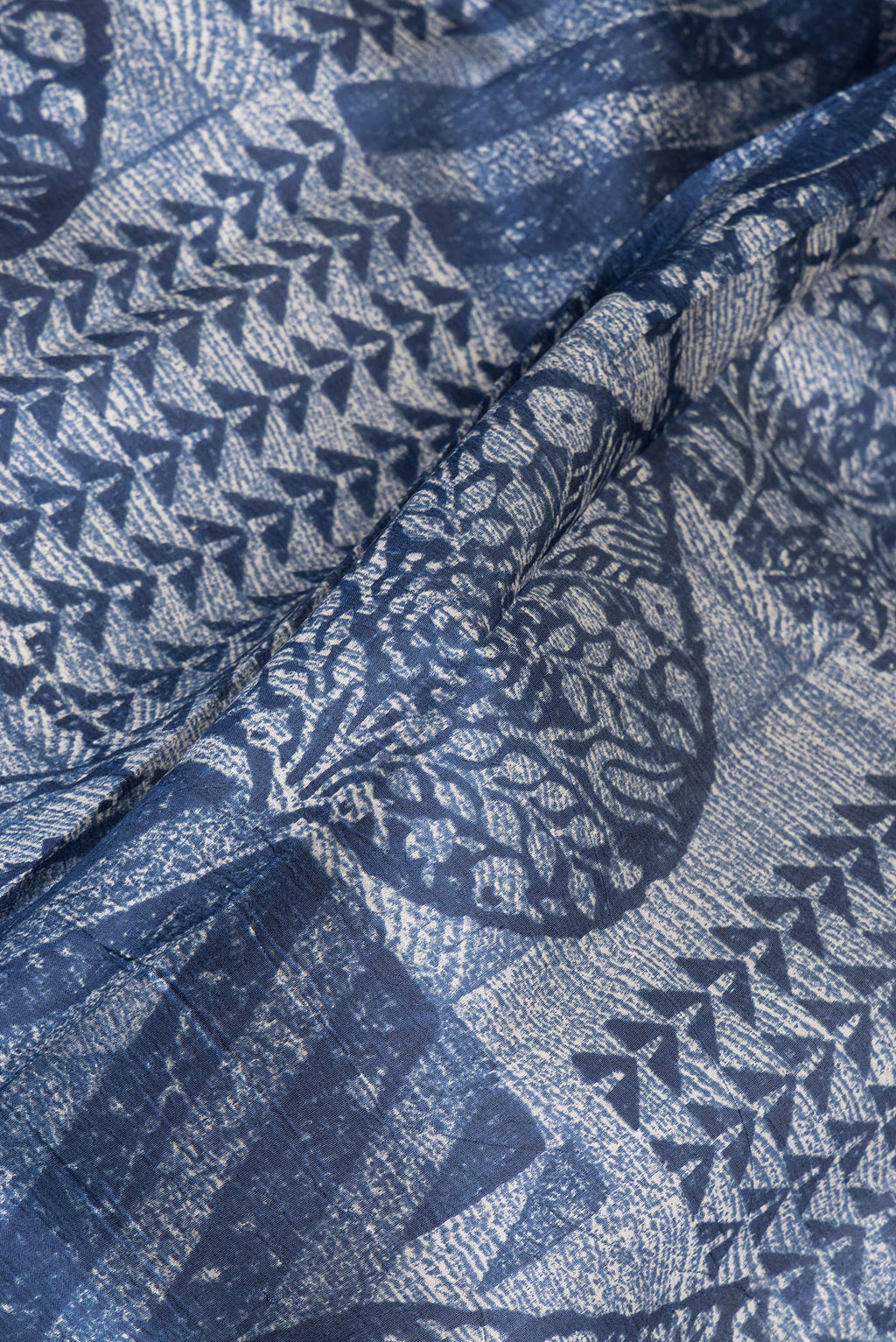 Close up of Navy Blue Tussar Silk Saree with Printed design on the body and Printed Border.  displaying folds