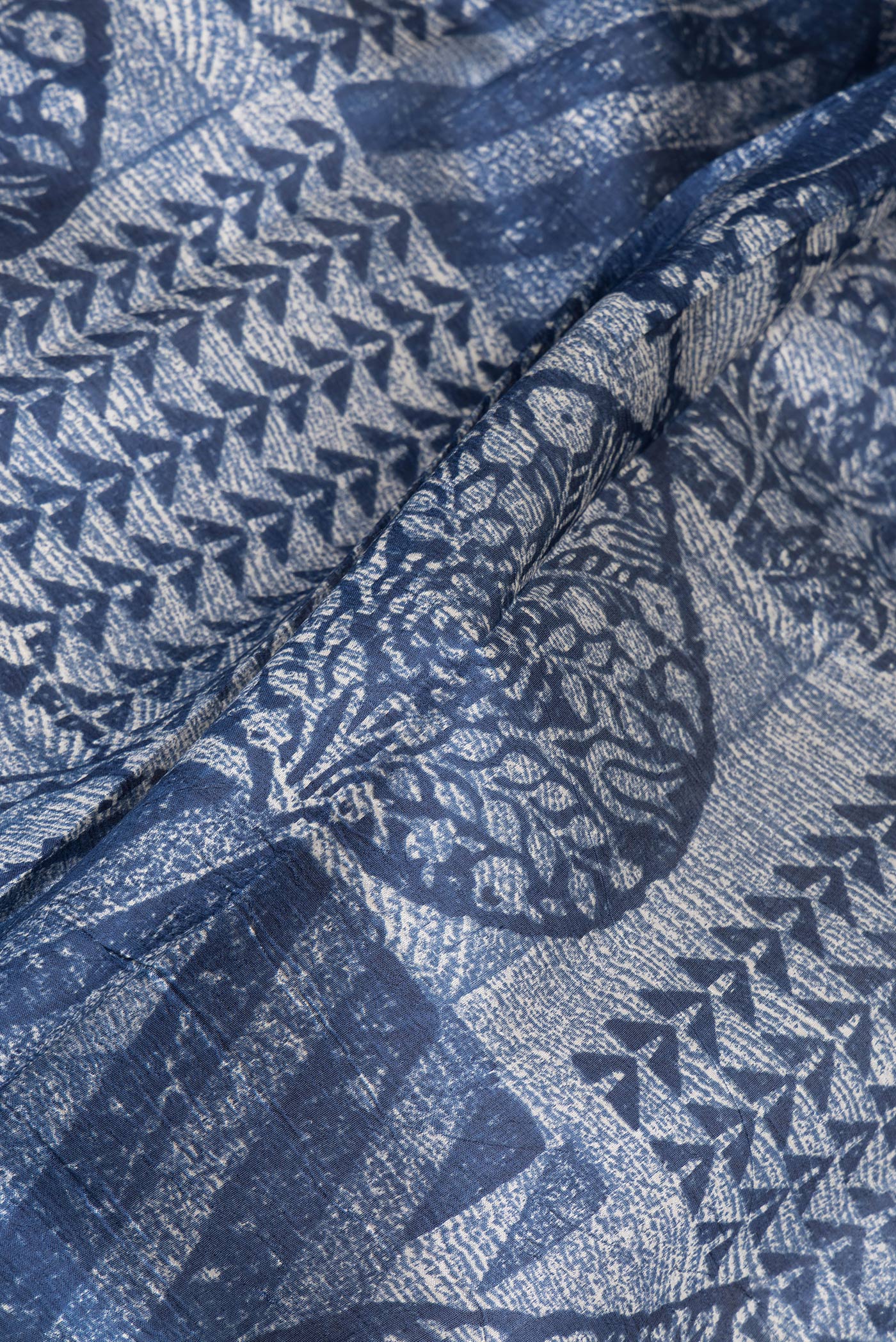 Close up of Navy Blue Tussar Silk Saree with Printed design on the body and Printed Border.  displaying folds