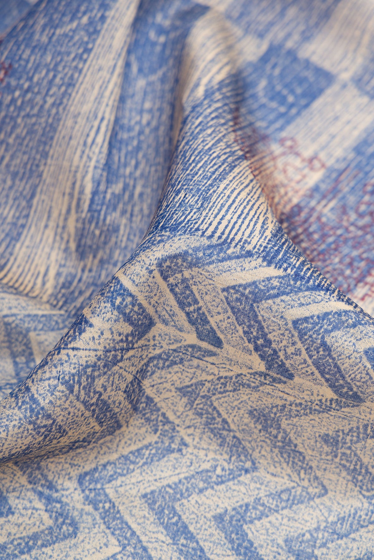 Close up of Peacock Blue Dual Tone Tussar Silk Saree with Printed design on the body and Printed Border.  displaying folds