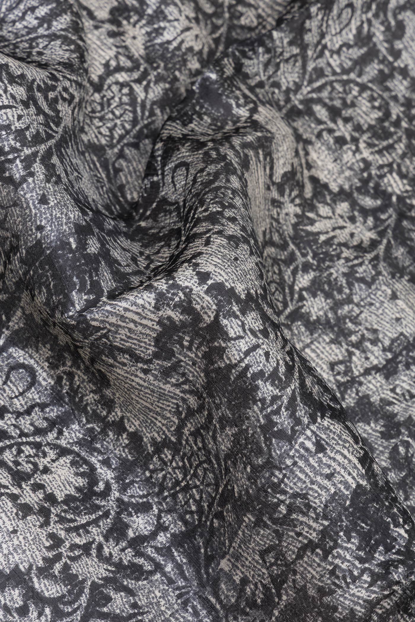 Close up of Black Tussar Silk Saree with Printed design on the body and Printed Border.  displaying folds