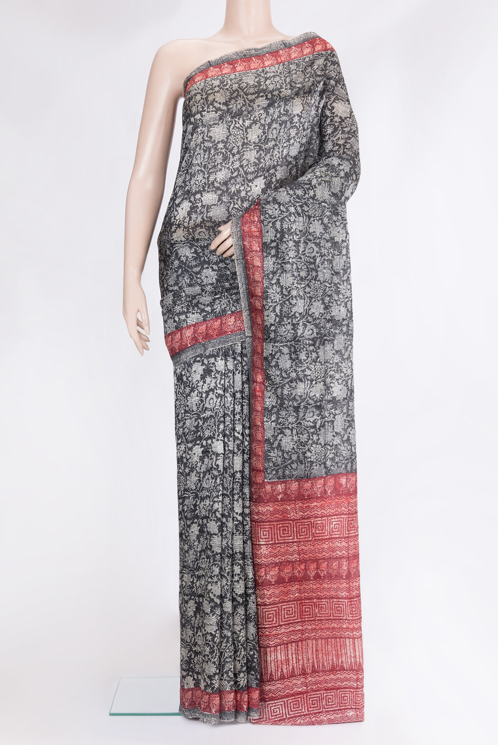 Black Tussar Silk Saree with Printed design on the body and Printed Border.  displayed on a mannequin