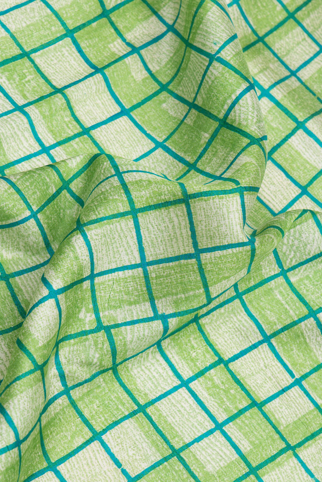 Close up of Green Dual Tone Tussar Silk Saree with Printed design on the body and Printed Border.  displaying folds