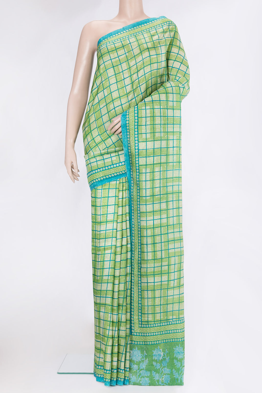 Green Dual Tone Tussar Silk Saree with Printed design on the body and Printed Border.  displayed on a mannequin