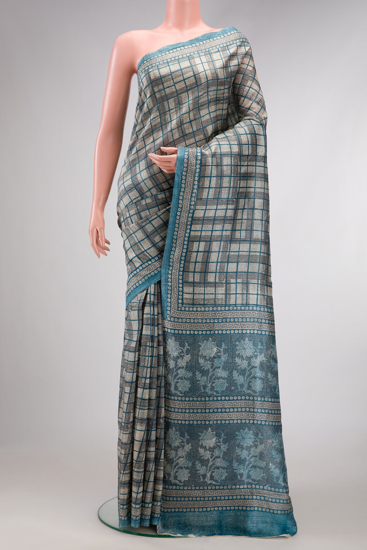 Grey Dual Tone Tussar Silk Saree with Checked design on the body and Fancy Border.  displayed on a mannequin