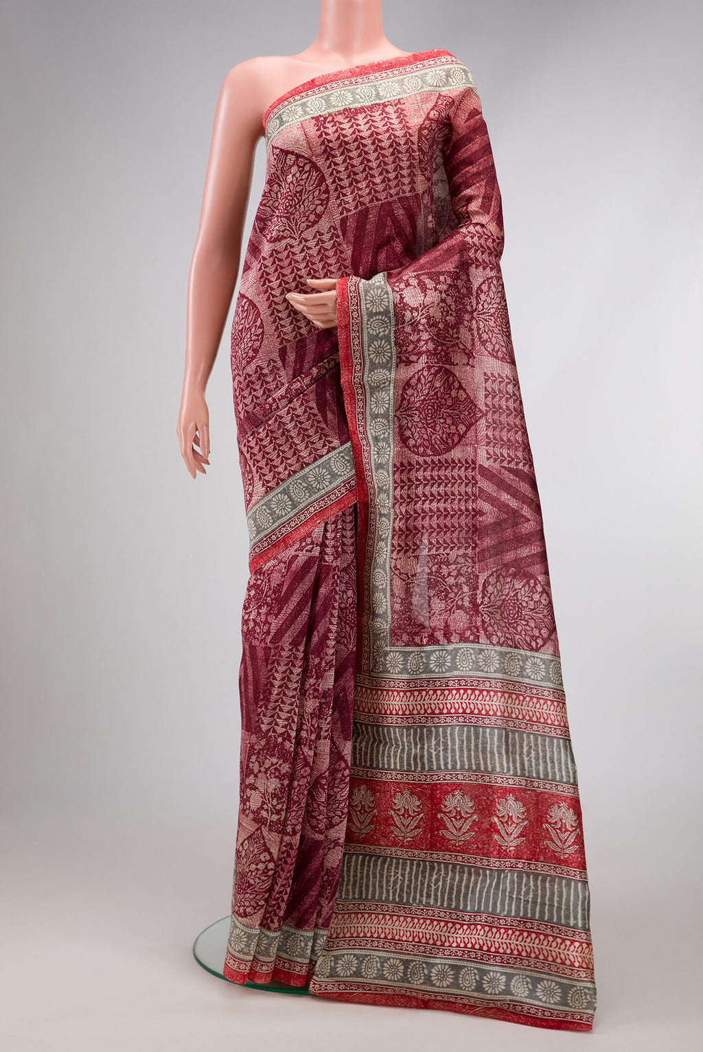 Maroon Dual Tone Tussar Silk Saree with Printed design on the body and Printed Border.  displayed on a mannequin