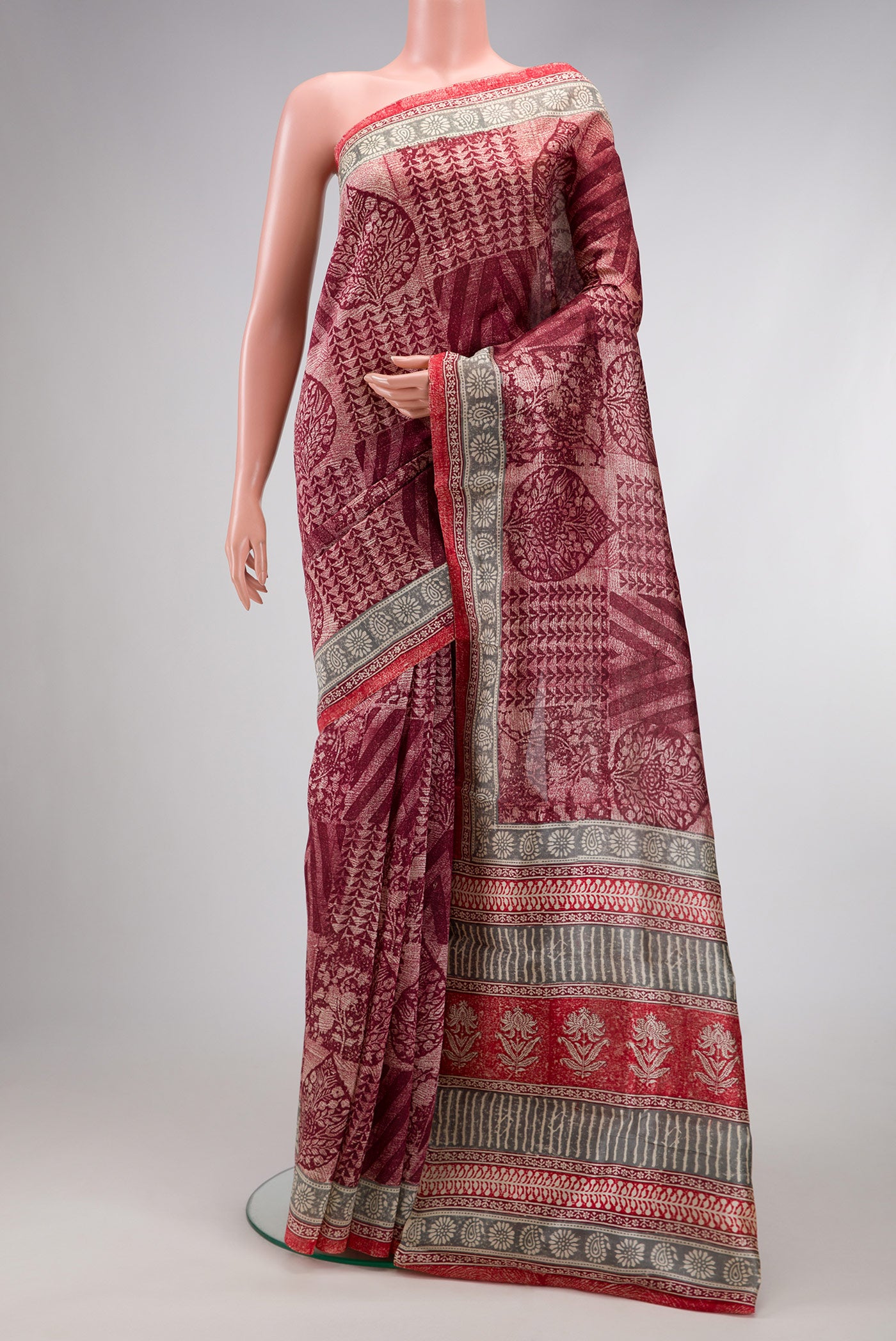 Maroon Dual Tone Tussar Silk Saree with Printed design on the body and Printed Border.  displayed on a mannequin