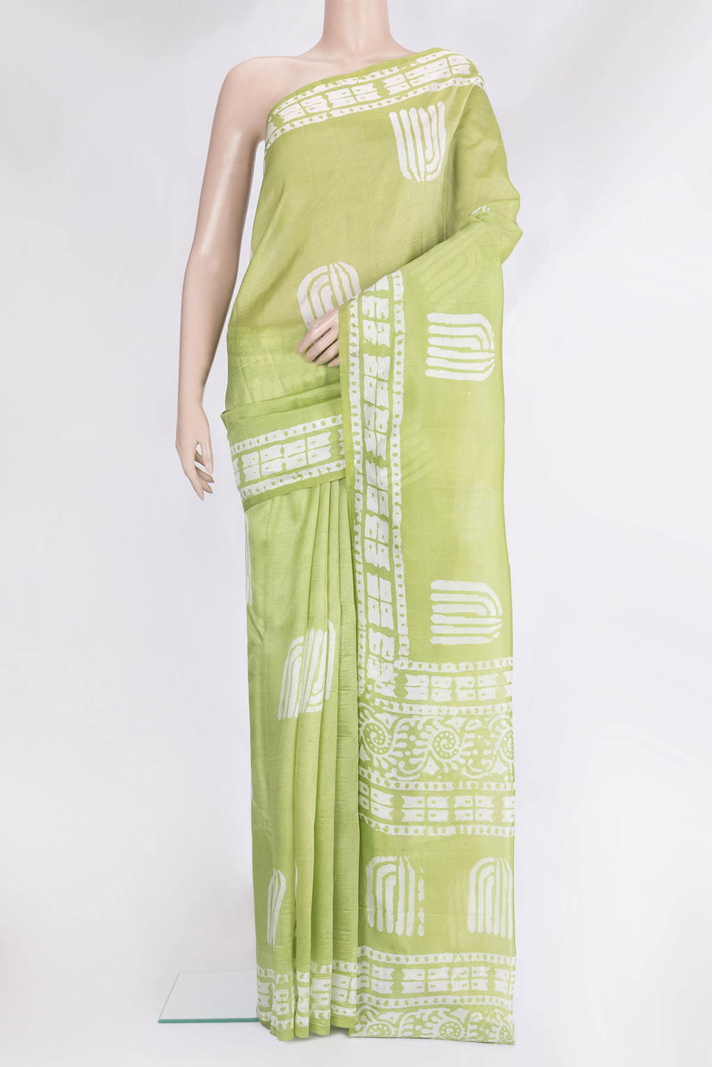 Pista Green Tussar Silk Saree with Printed design on the body and Printed Border.  displayed on a mannequin