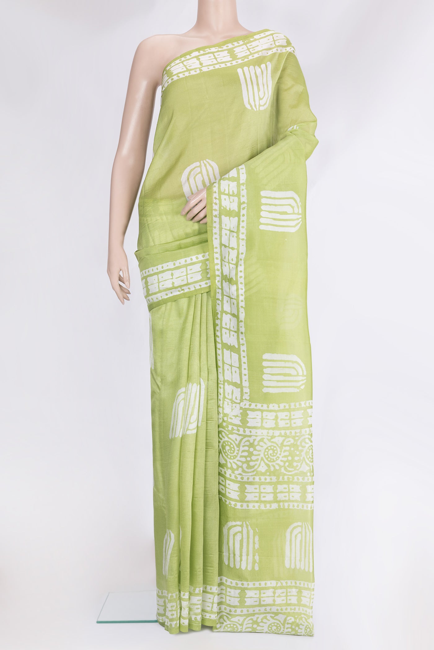 Pista Green Tussar Silk Saree with Printed design on the body and Printed Border.  displayed on a mannequin