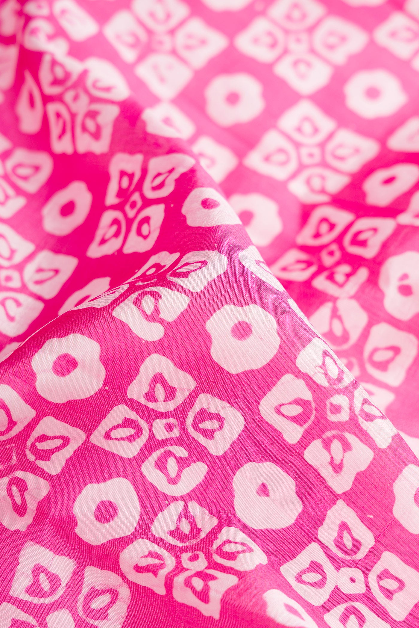 Close up of Pink Dual Tone Tussar Silk Saree with Printed design on the body and Printed Border.  displaying folds