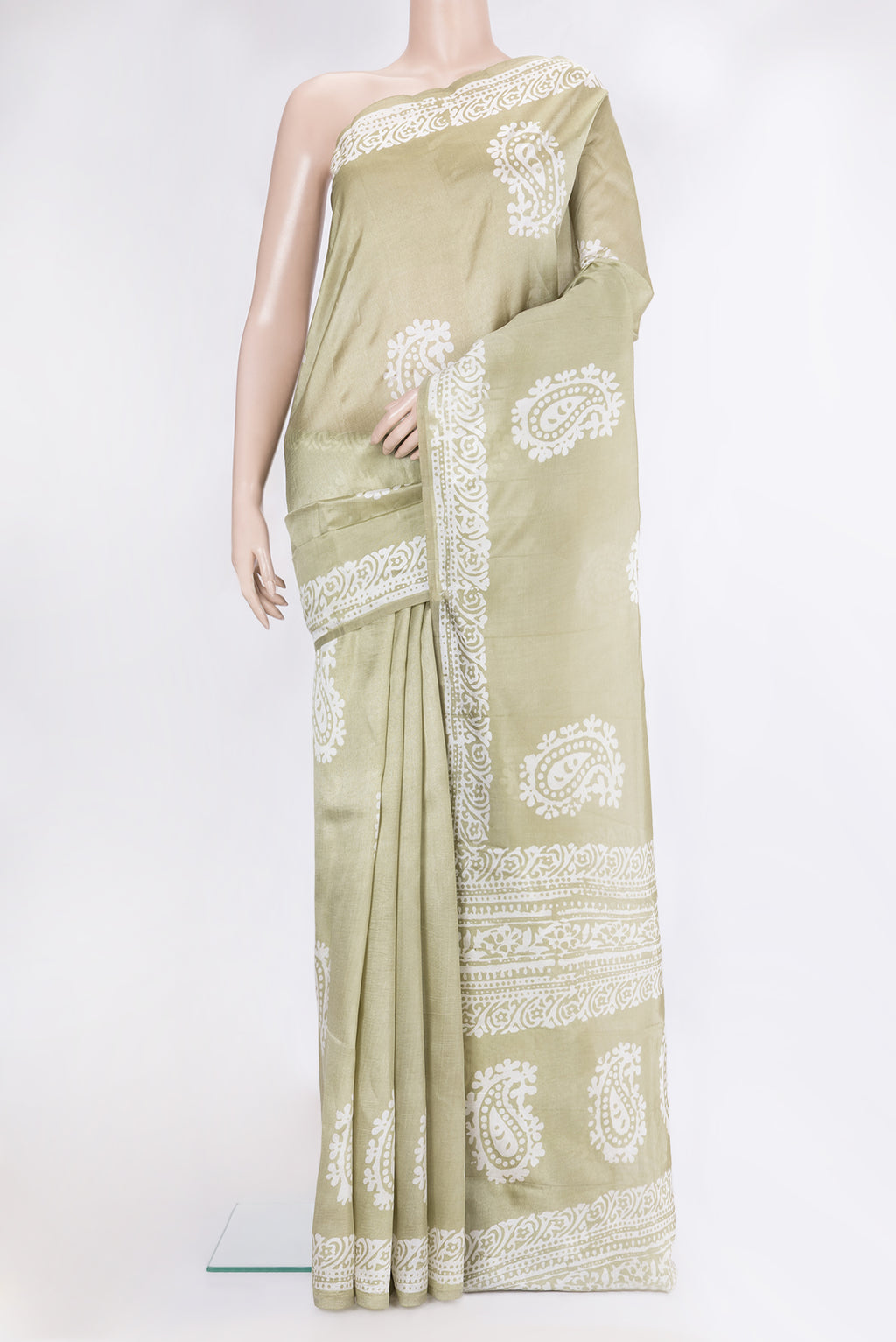 Pista Green Dual Tone Tussar Silk Saree with Batik Print on the body and Printed Border.  displayed on a mannequin