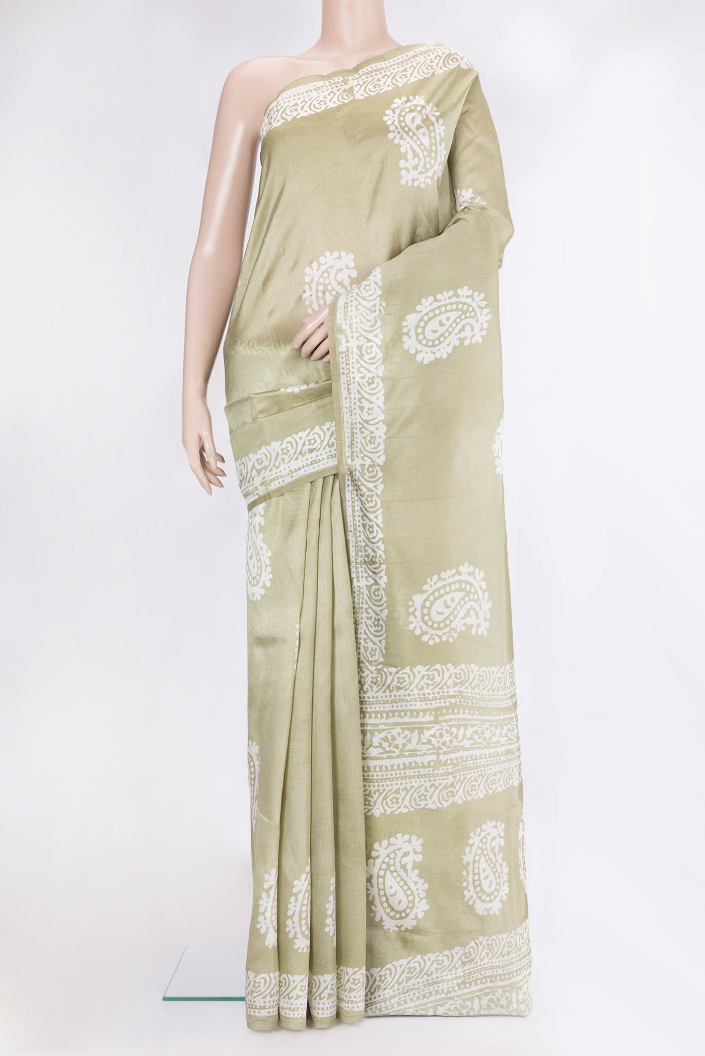 Pista Green Dual Tone Tussar Silk Saree with Batik Print on the body and Printed Border.  displayed on a mannequin