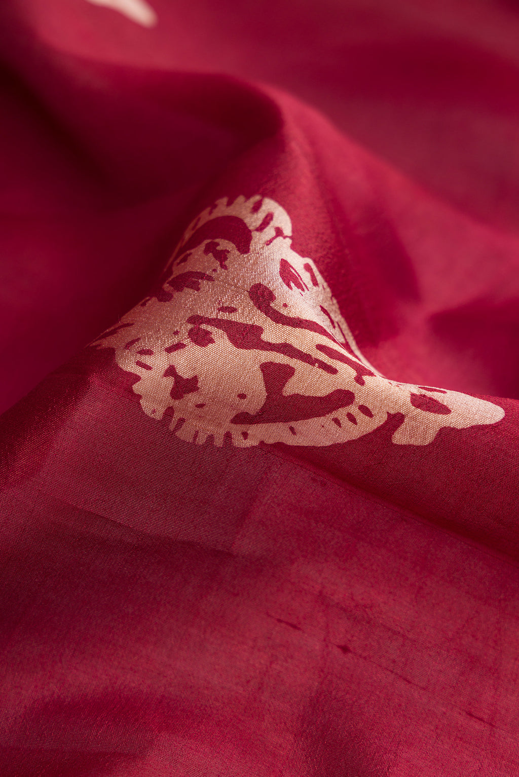 Close up of Coffee Brown Dual Tone Tussar Silk Saree with Printed design on the body and Fancy Border.  displaying folds