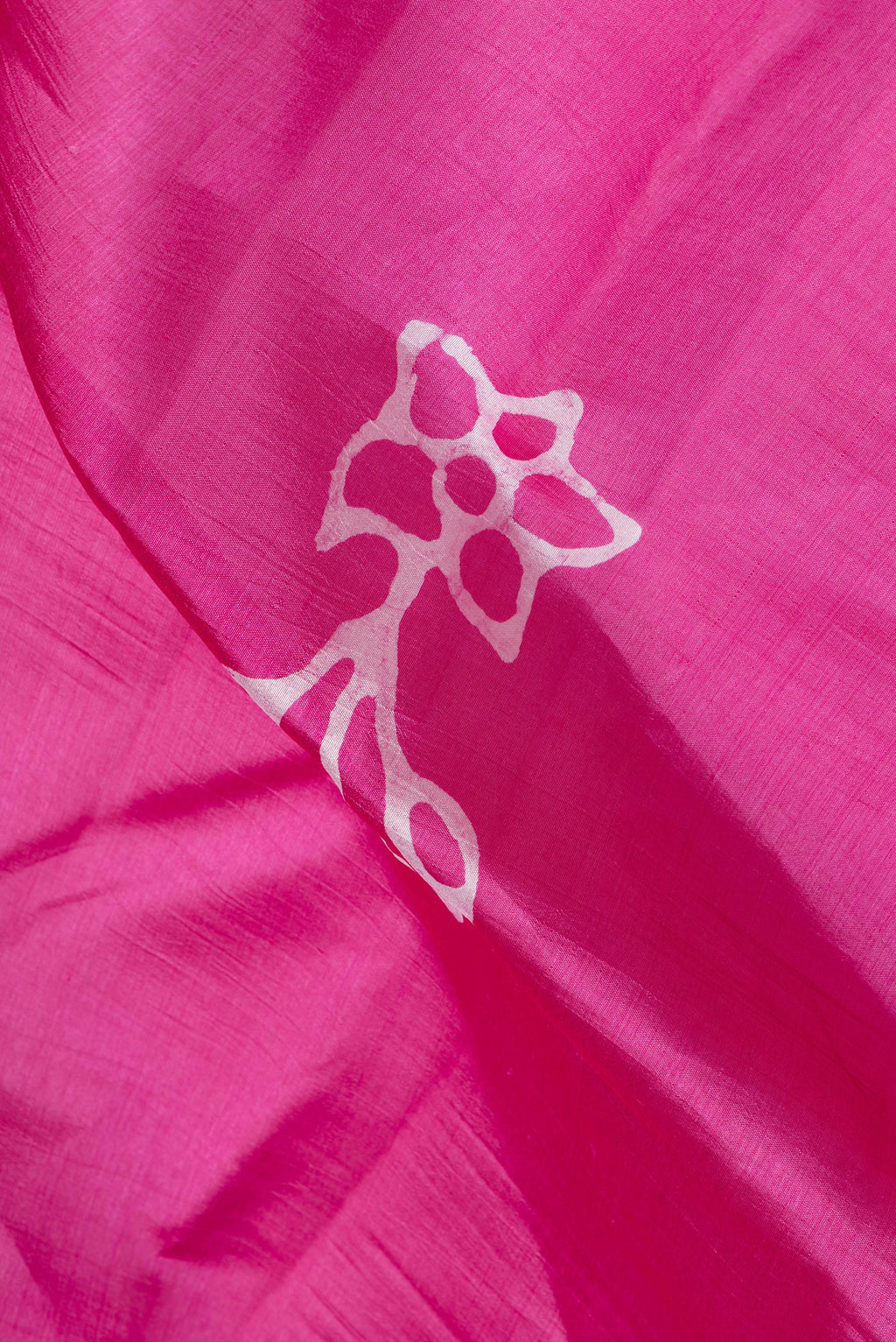 Close up of Rose pink Dual Tone Tussar Silk Saree with Batik Print on the body and Printed Border.  displaying folds