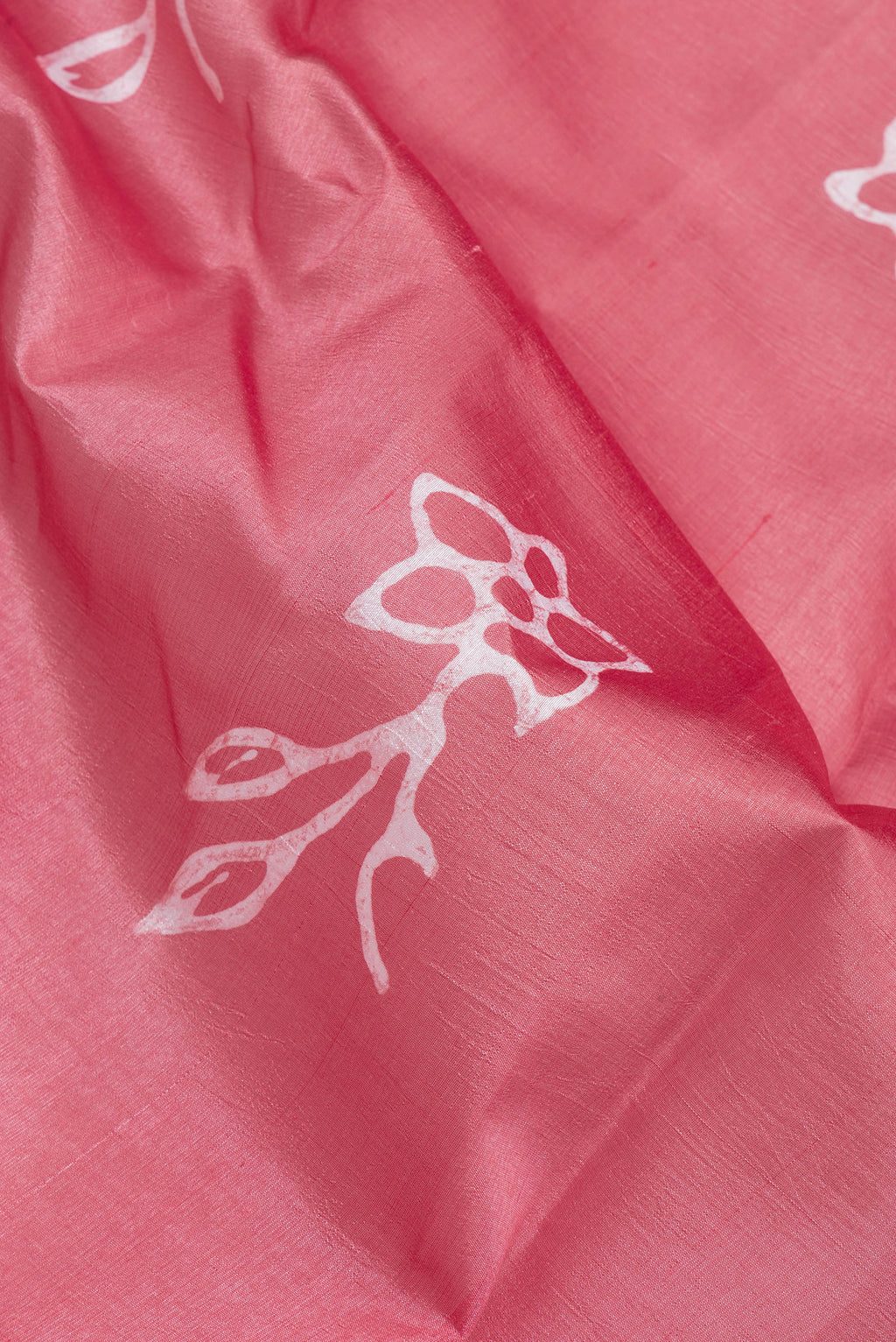Close up of Pink Tussar Silk Saree with Printed design on the body and Printed Border.  displaying folds