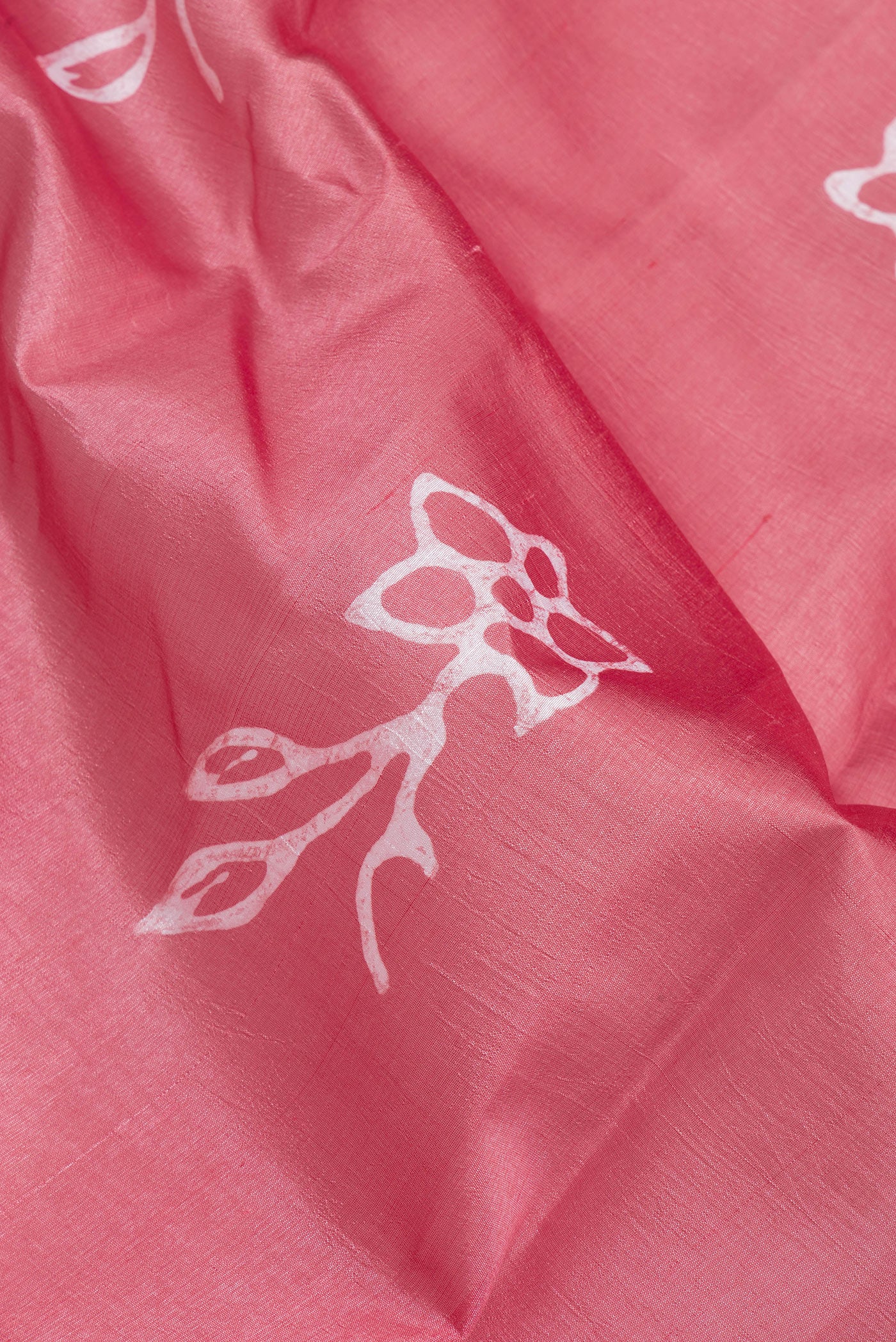 Close up of Pink Tussar Silk Saree with Printed design on the body and Printed Border.  displaying folds