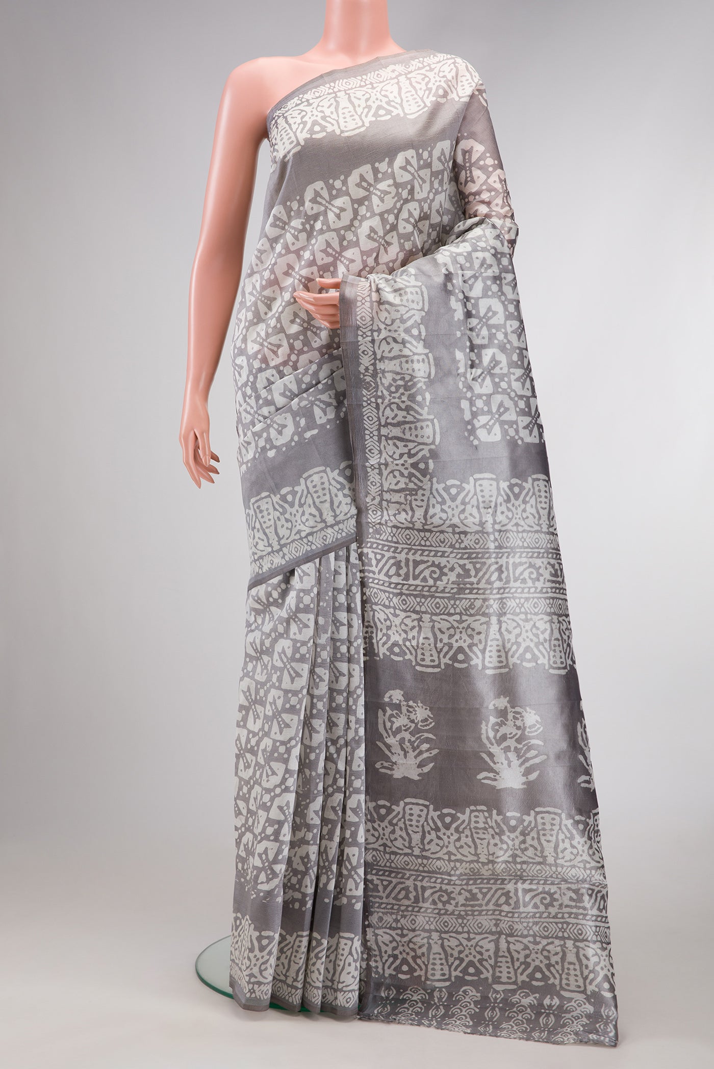Grey Dual Tone Tussar Silk Saree with Printed design on the body and Printed Border.  displayed on a mannequin