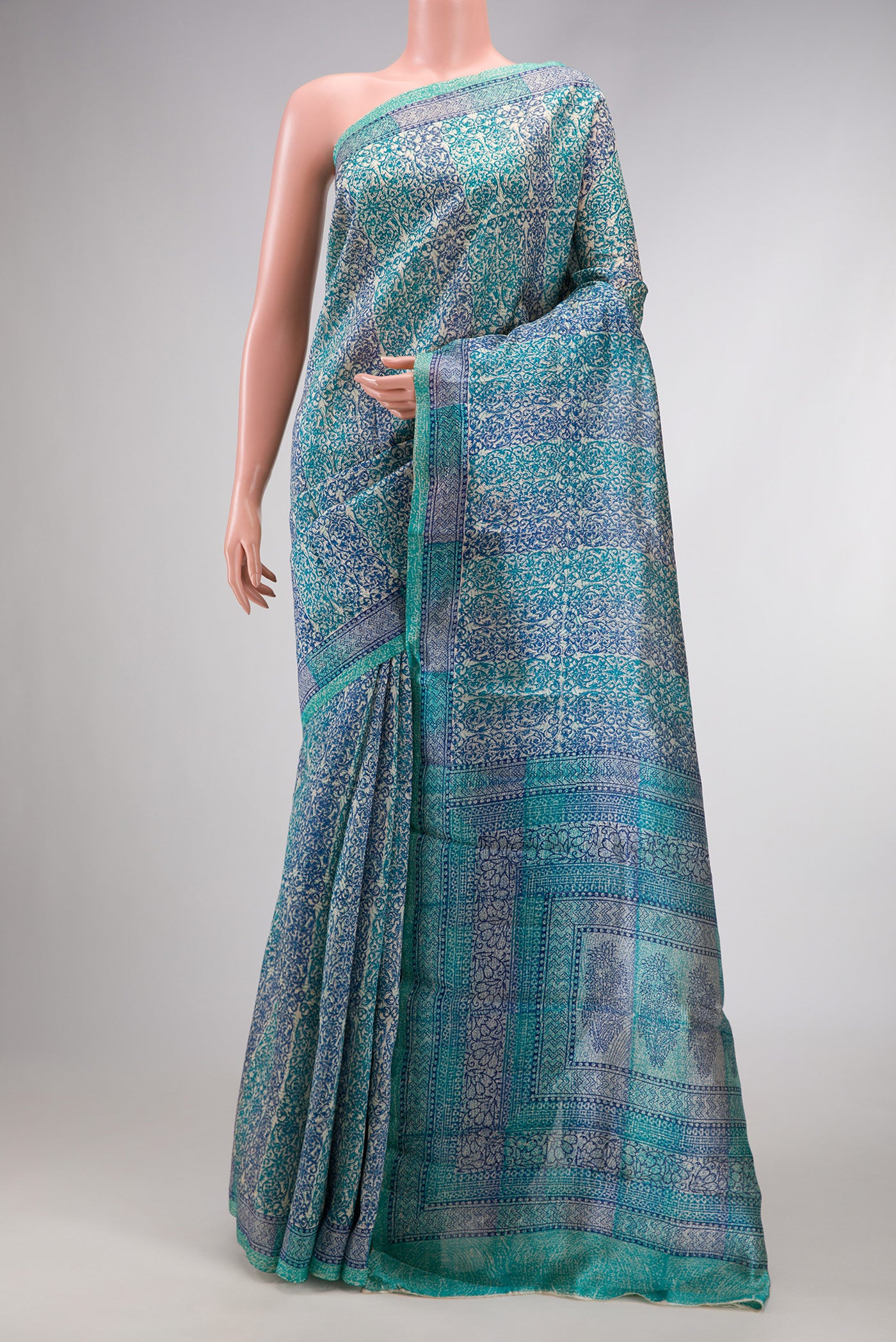 Sky Blue Dual Tone Tussar Silk Saree with Printed design on the body and Printed Border.  displayed on a mannequin