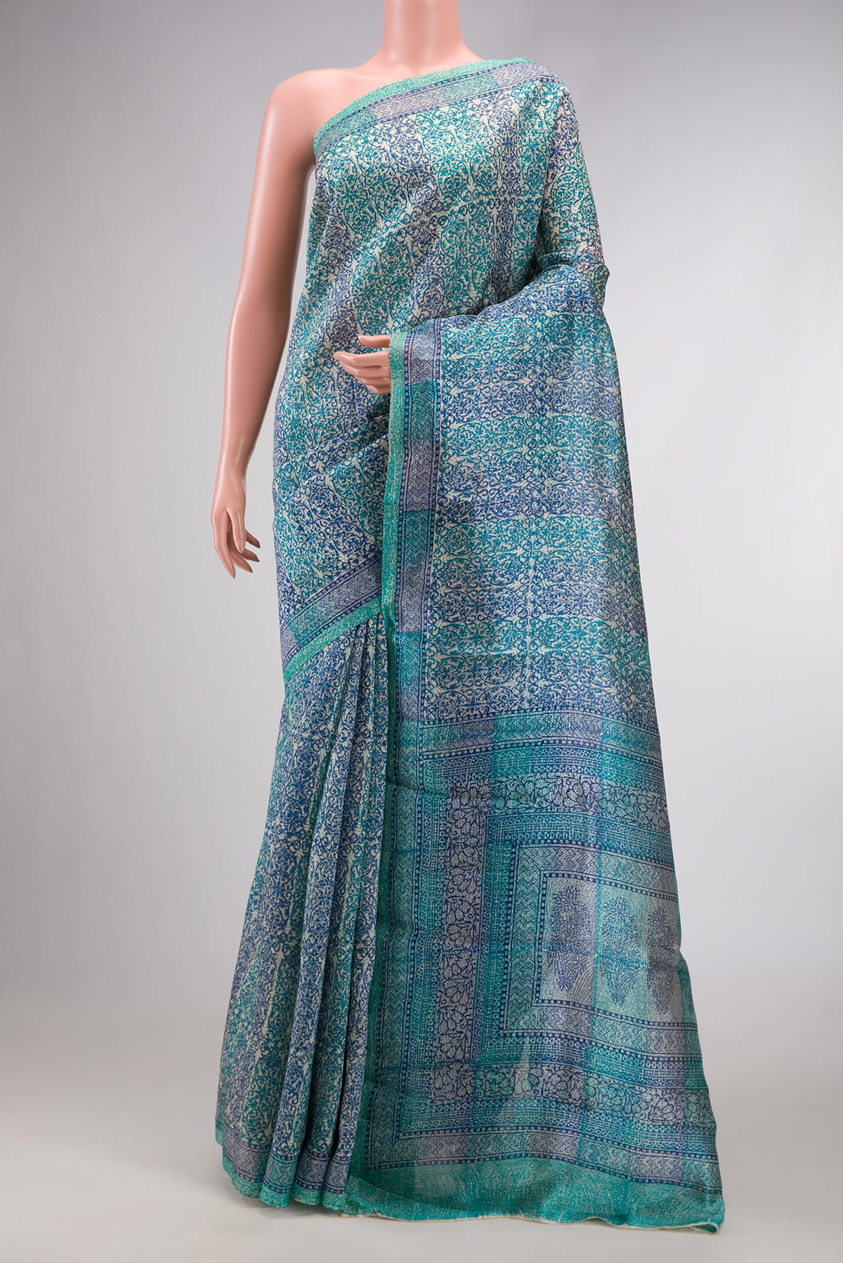 Sky Blue Dual Tone Tussar Silk Saree with Printed design on the body and Printed Border.  displayed on a mannequin