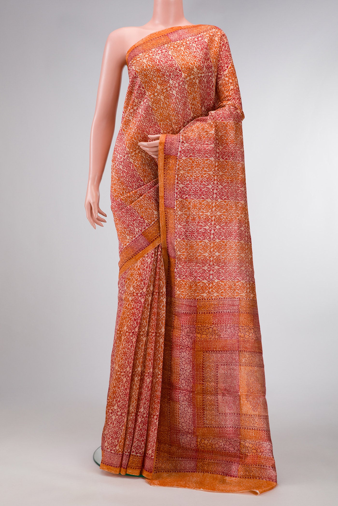 Orange Dual Tone Tussar Silk Saree with Printed design on the body and Printed Border.  displayed on a mannequin