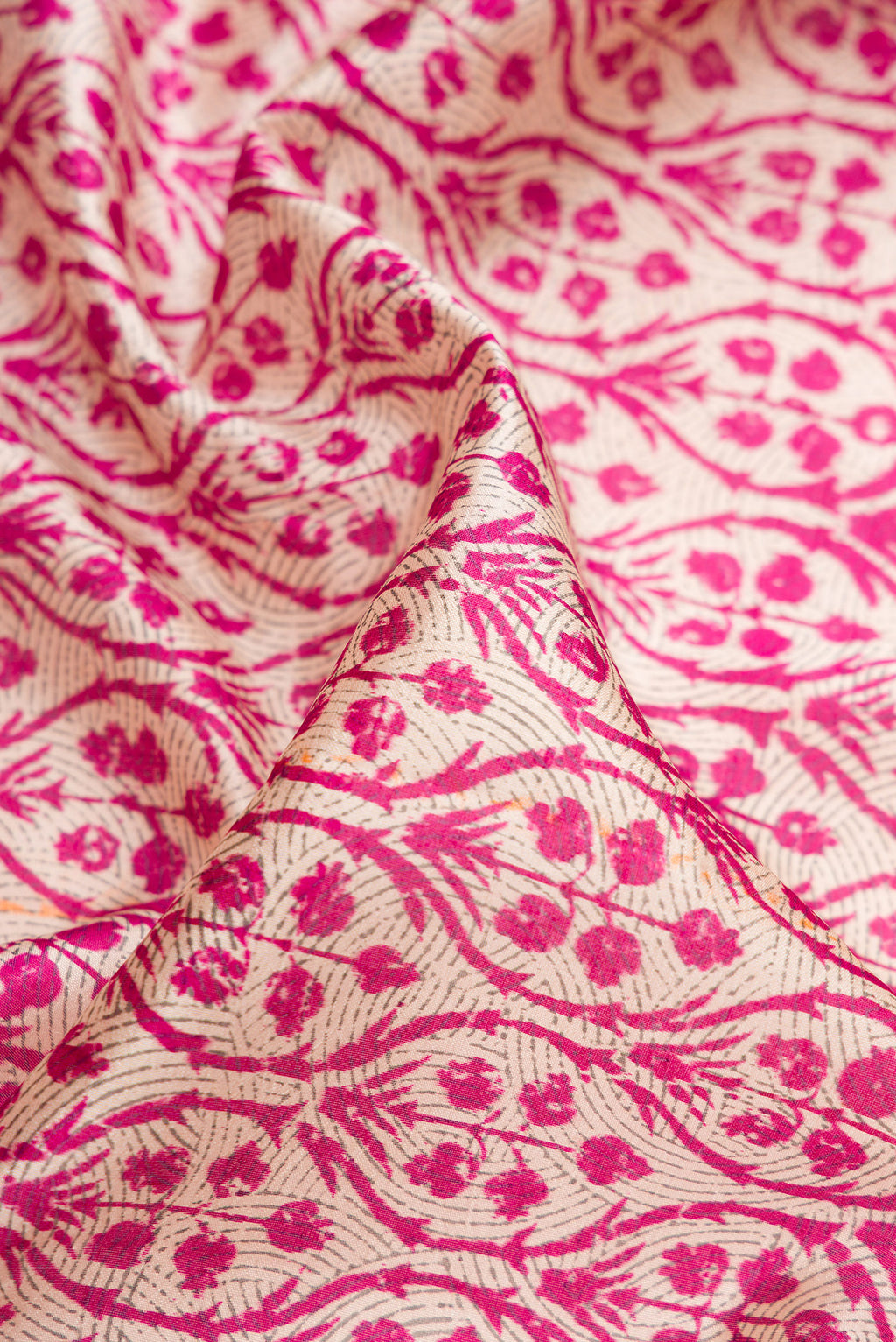 Close up of Pink Dual Tone Tussar Silk Saree with Printed design on the body and Printed Border.  displaying folds