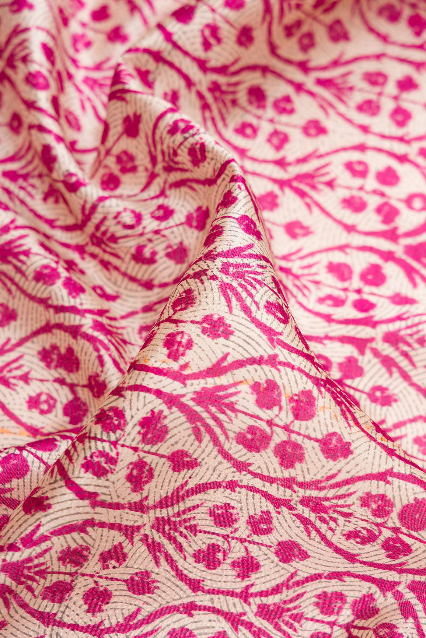 Close up of Pink Dual Tone Tussar Silk Saree with Printed design on the body and Printed Border.  displaying folds