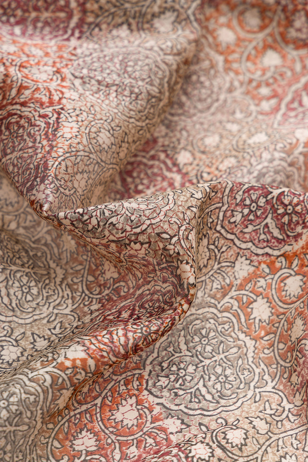 Close up of Grey Dual Tone Tussar Silk Saree with Printed design on the body and Printed Border.  displaying folds